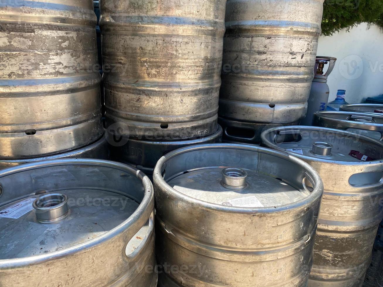 metal barrels at a construction site. large containers for liquid and bulk building materials. barrels have a black lid so as not to spill the liquid photo