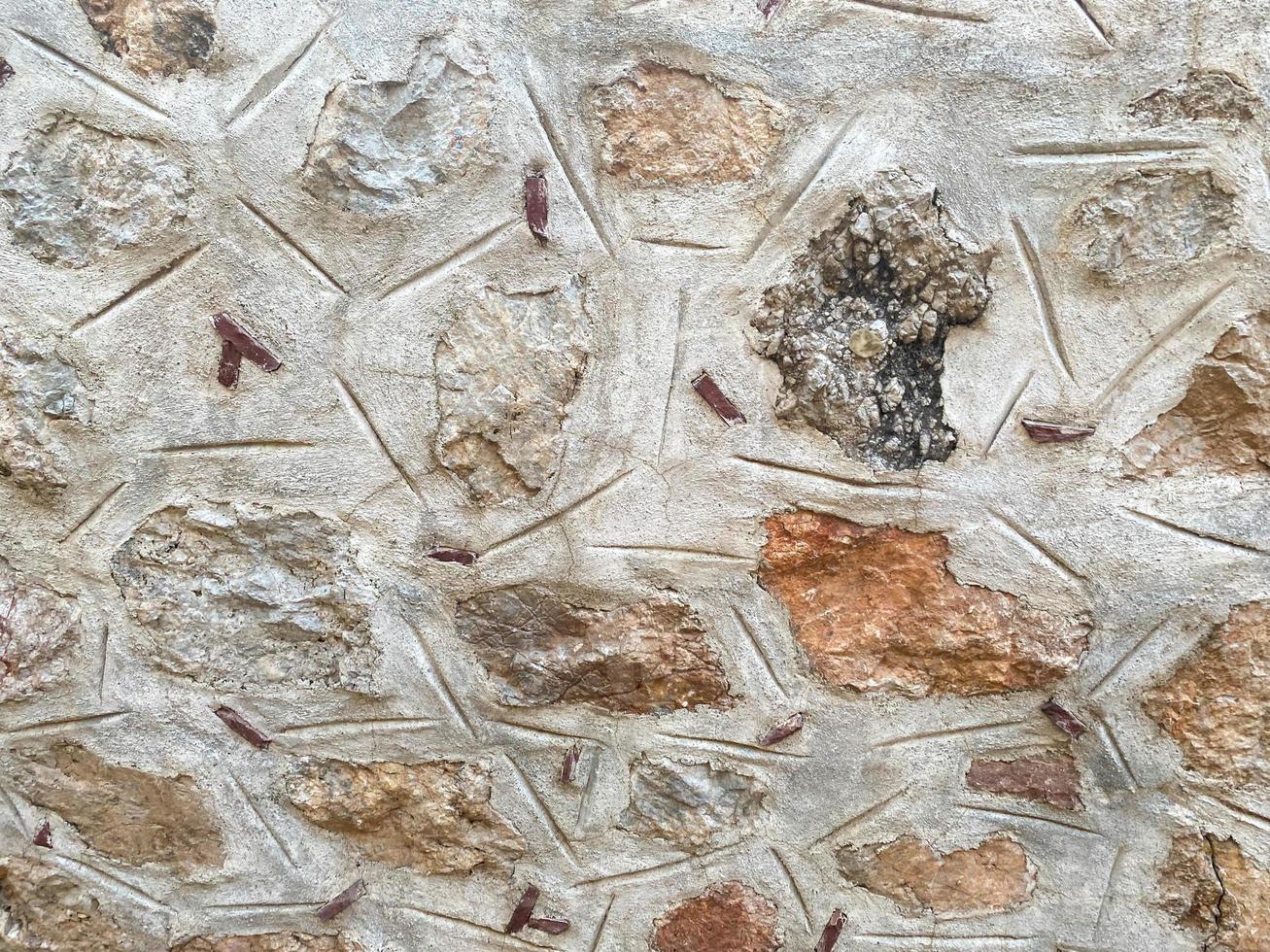Background, texture, stone wall of round stones cobblestones bricks natural surface natural sharp convex rough stone cobblestone with cracks photo