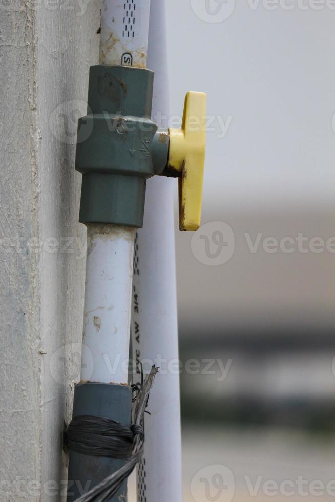 Valves or taps attached to pipes to open and close flow photo