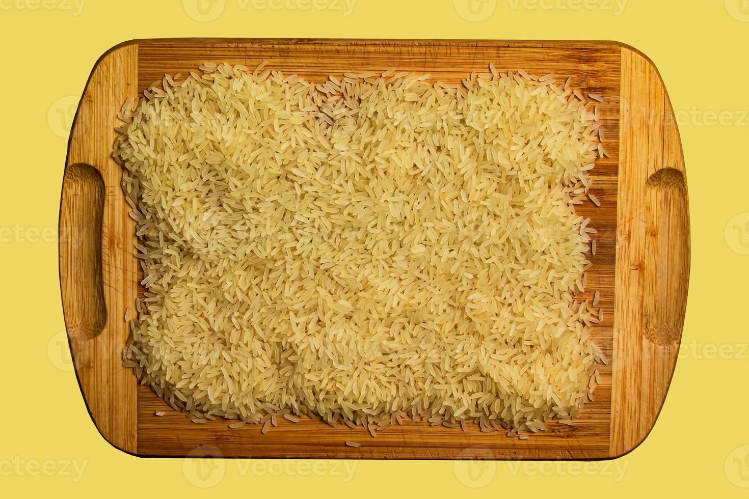 Background of long grain parboiled uncooked rice. Rice groats as background and texture. photo