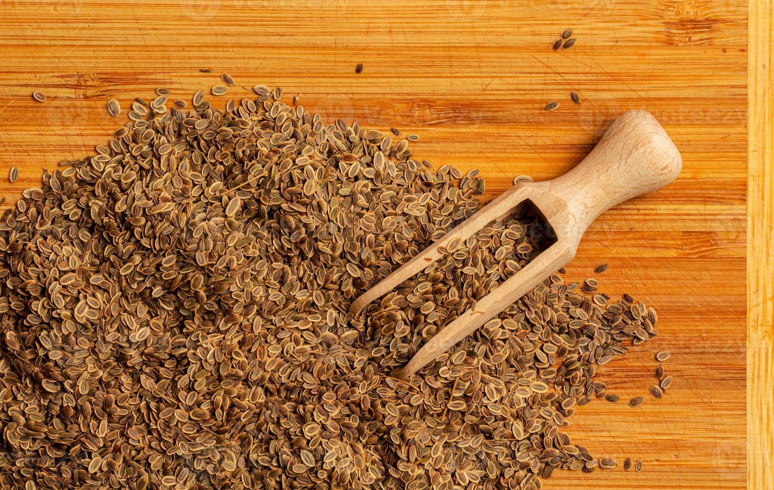 Whole dill seeds close-up. Anetum graveolens organic fruit for medicinal herbs concept. Spices, seasonings and condiments. Growing dill. The texture of the seeds. photo