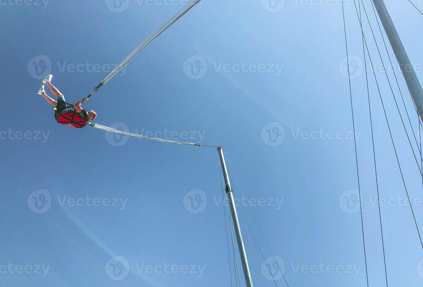 jumping on a high mountain. rope jumping, trampoline on the edge of the mountains. a large structure, a catapult for launching people into the sky photo