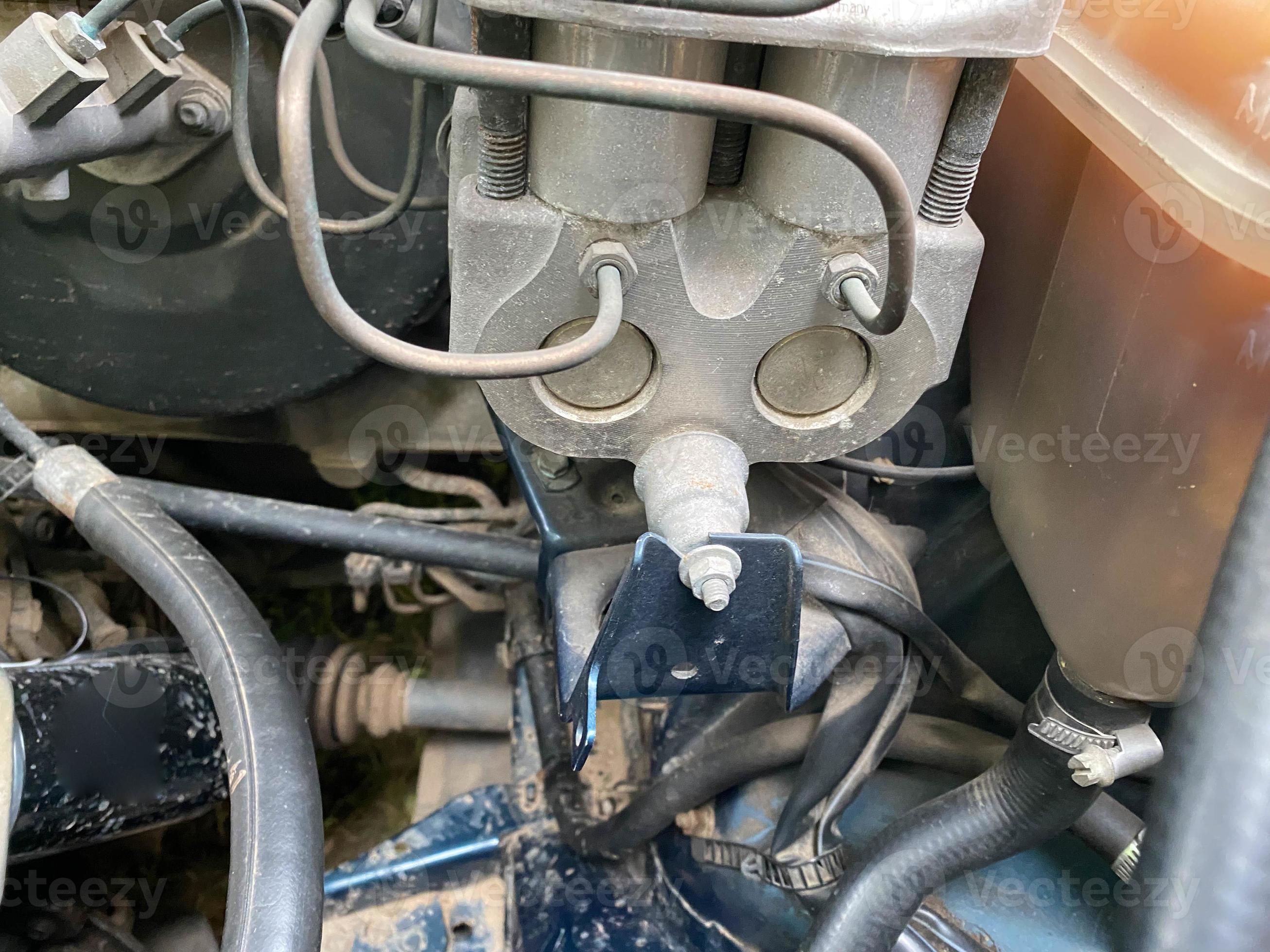 The engine compartment and engine of a modern car. In the center of the