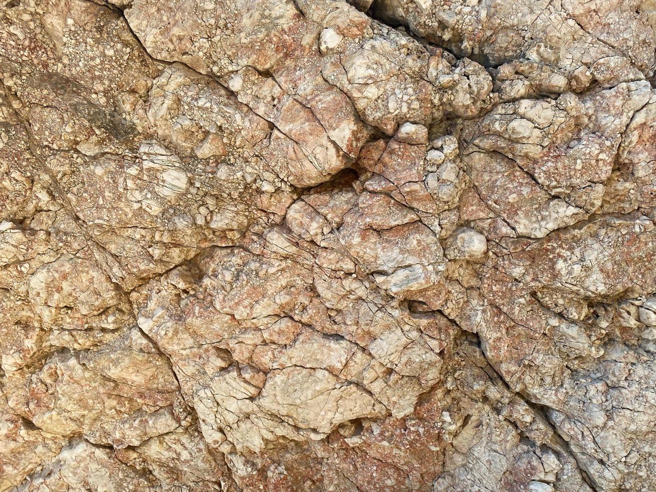 Texture of stone natural rock yellow background with cracks photo