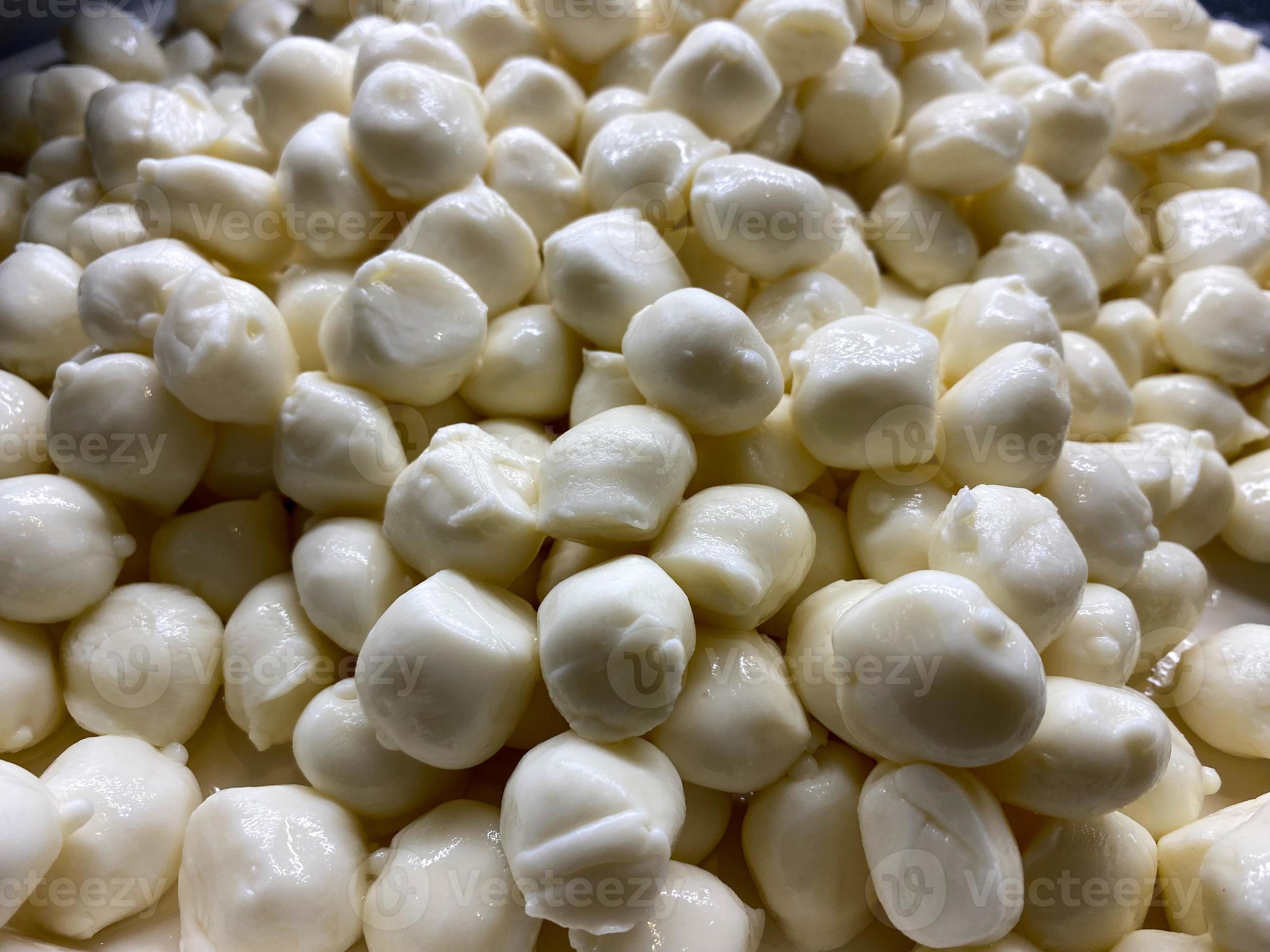 Lots of white balls of delicious fresh round mozzarella cheese