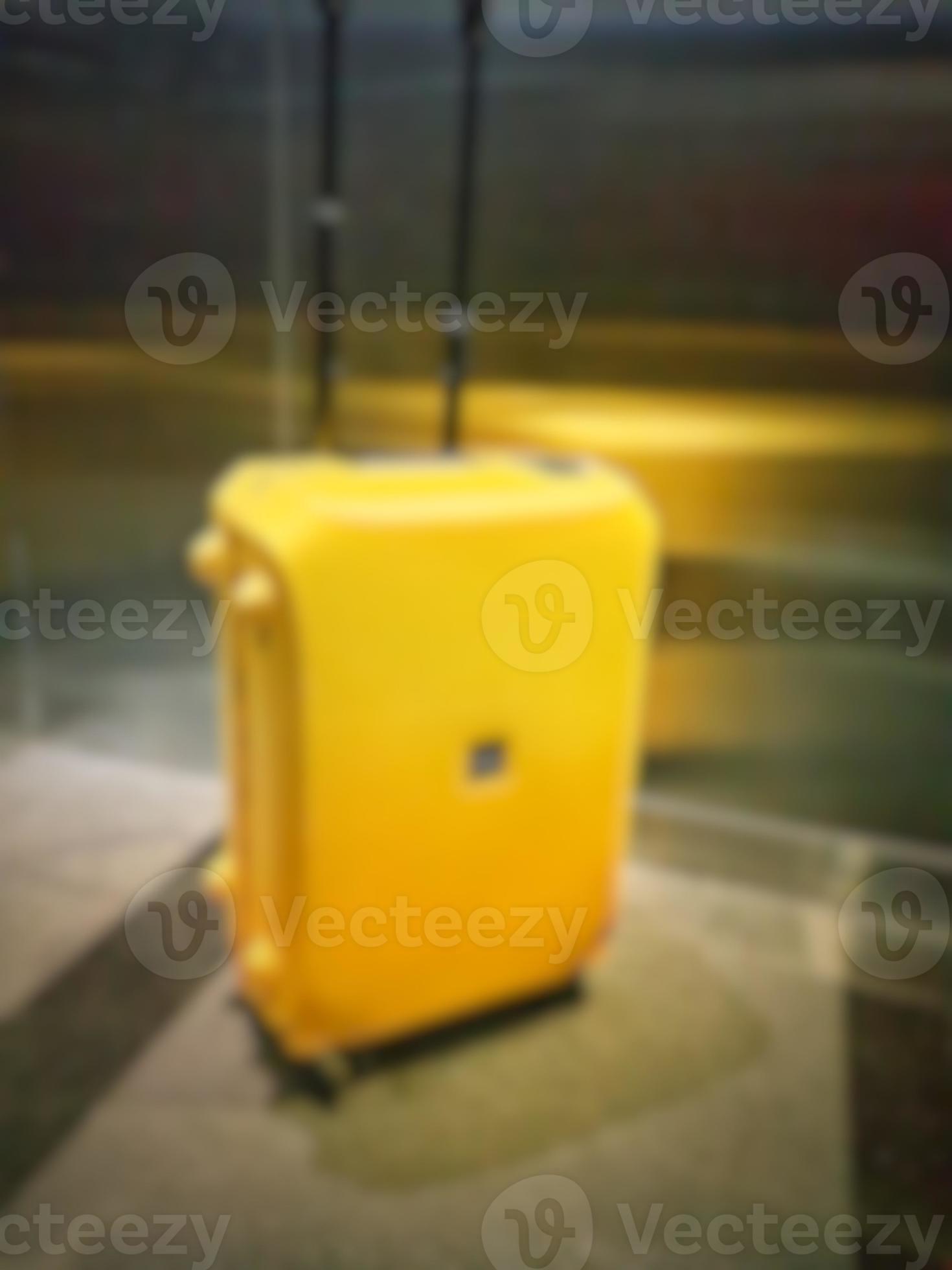 Defocused blurred photo of a yellow suitcase 15469701 Stock Photo at Vecteezy
