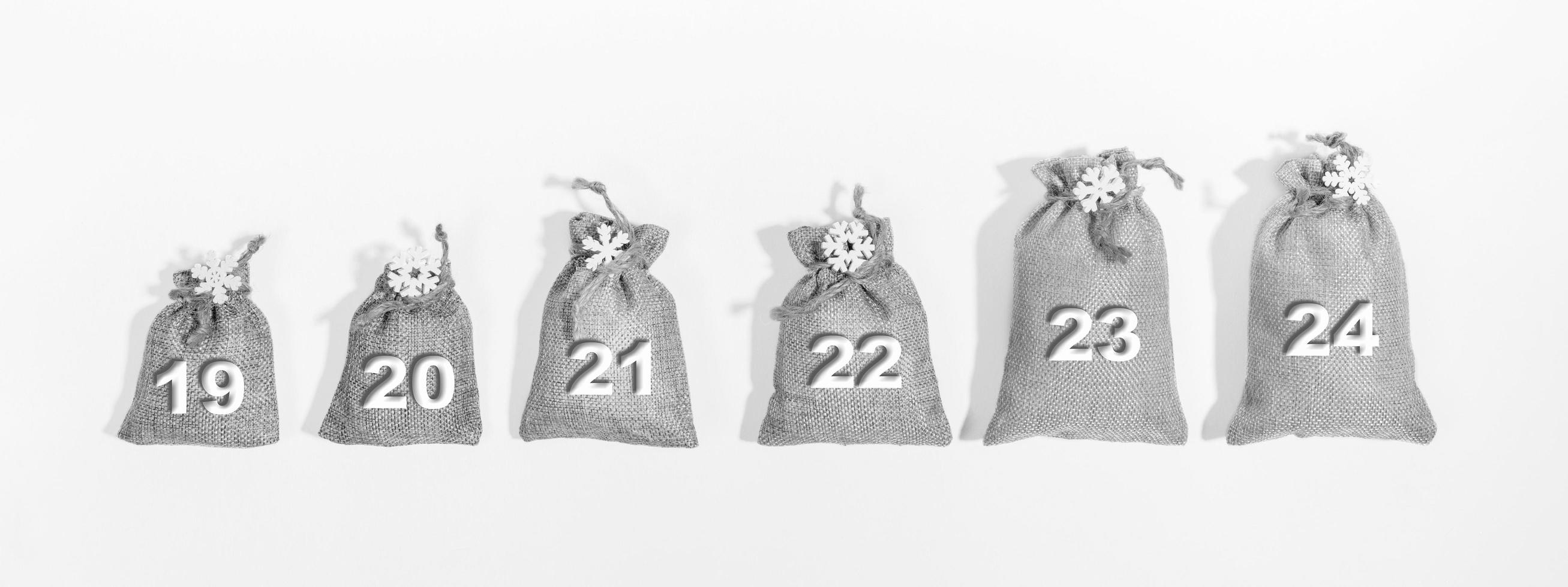 19 - 24 advent calendar - matting bags with numbers and snowflakes on them. Black and white. Banner. photo