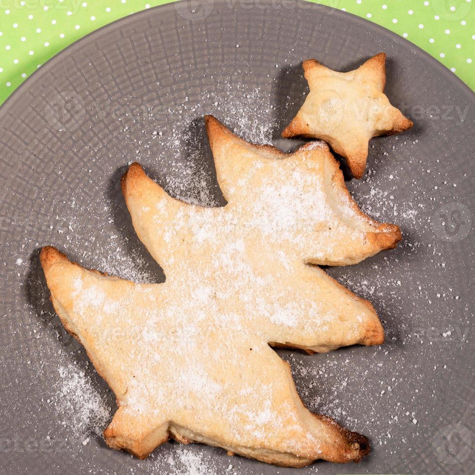 Homemade baking as Christmas tree on round grey plate close up. View from above. photo