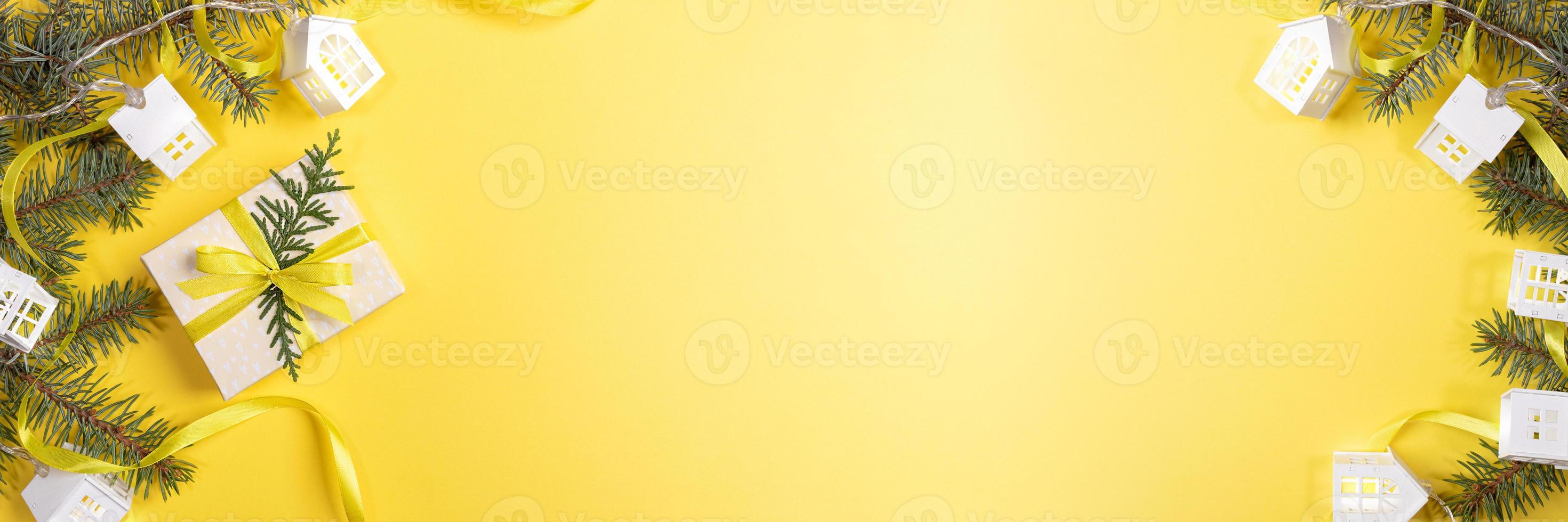 Christmas, New Year festive banner. DIY gift box, green fir branches, Xmas lights white lodges on yellow. Copy space. photo