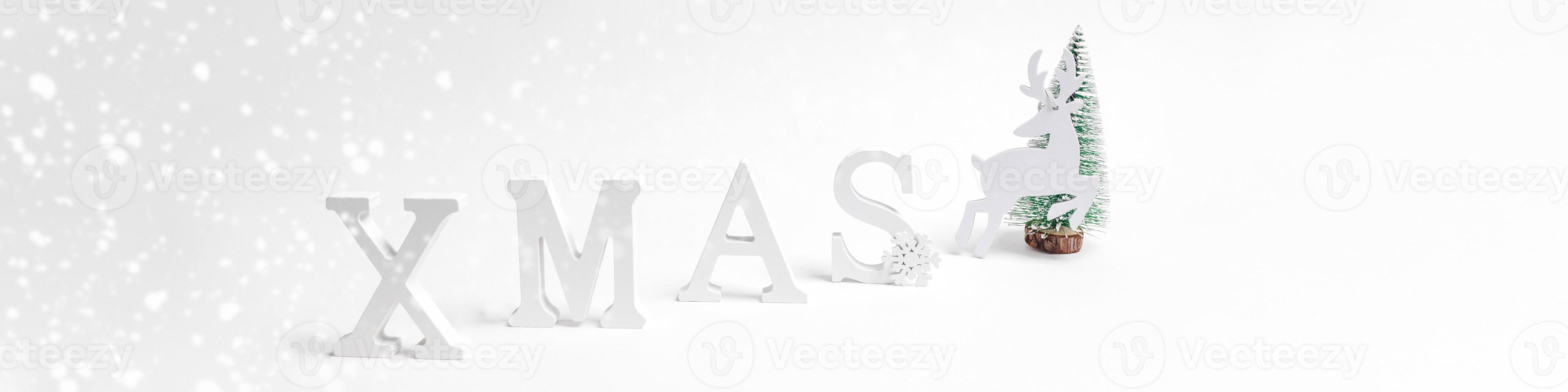 Christmas festive trendy minimal wide white banner with Christmas decorations letters XMAS, Xmas tree, deer on white. photo