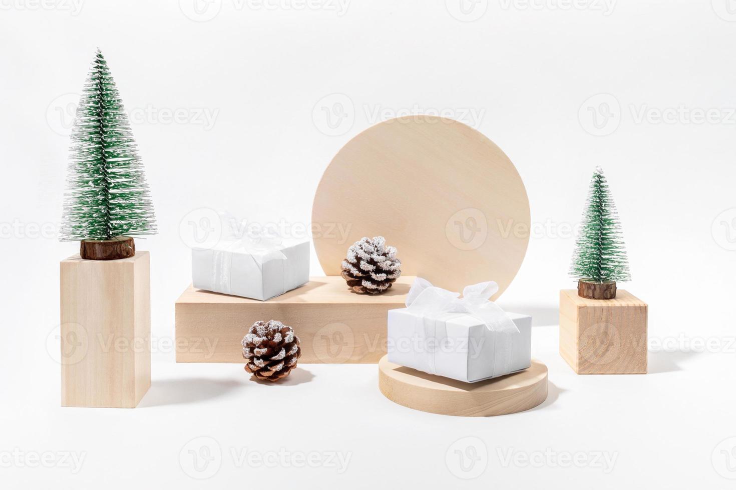 Trendy minimal Xmas holiday composition with Christmas decorations on wooden podiums in neutral color. photo