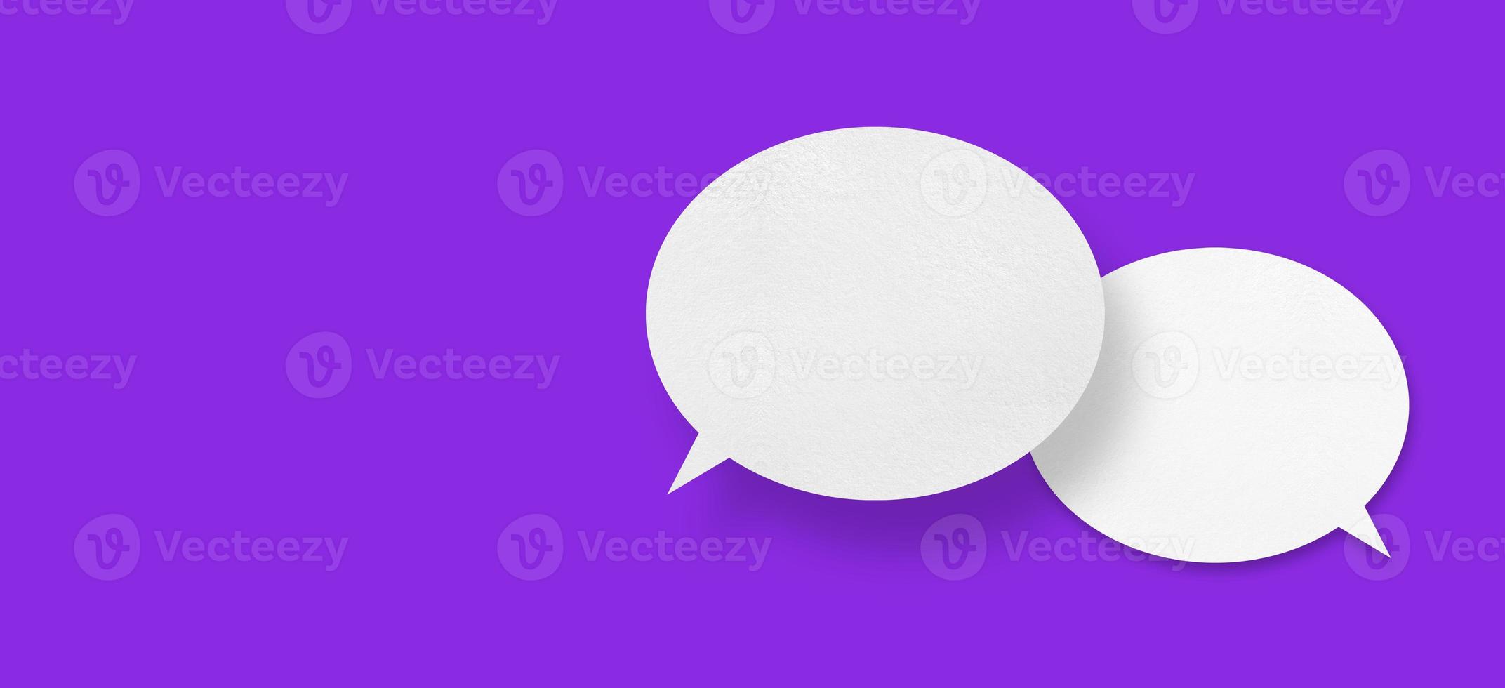 White paper in the shape of speech bubbles against a purple background. communication bubbles photo