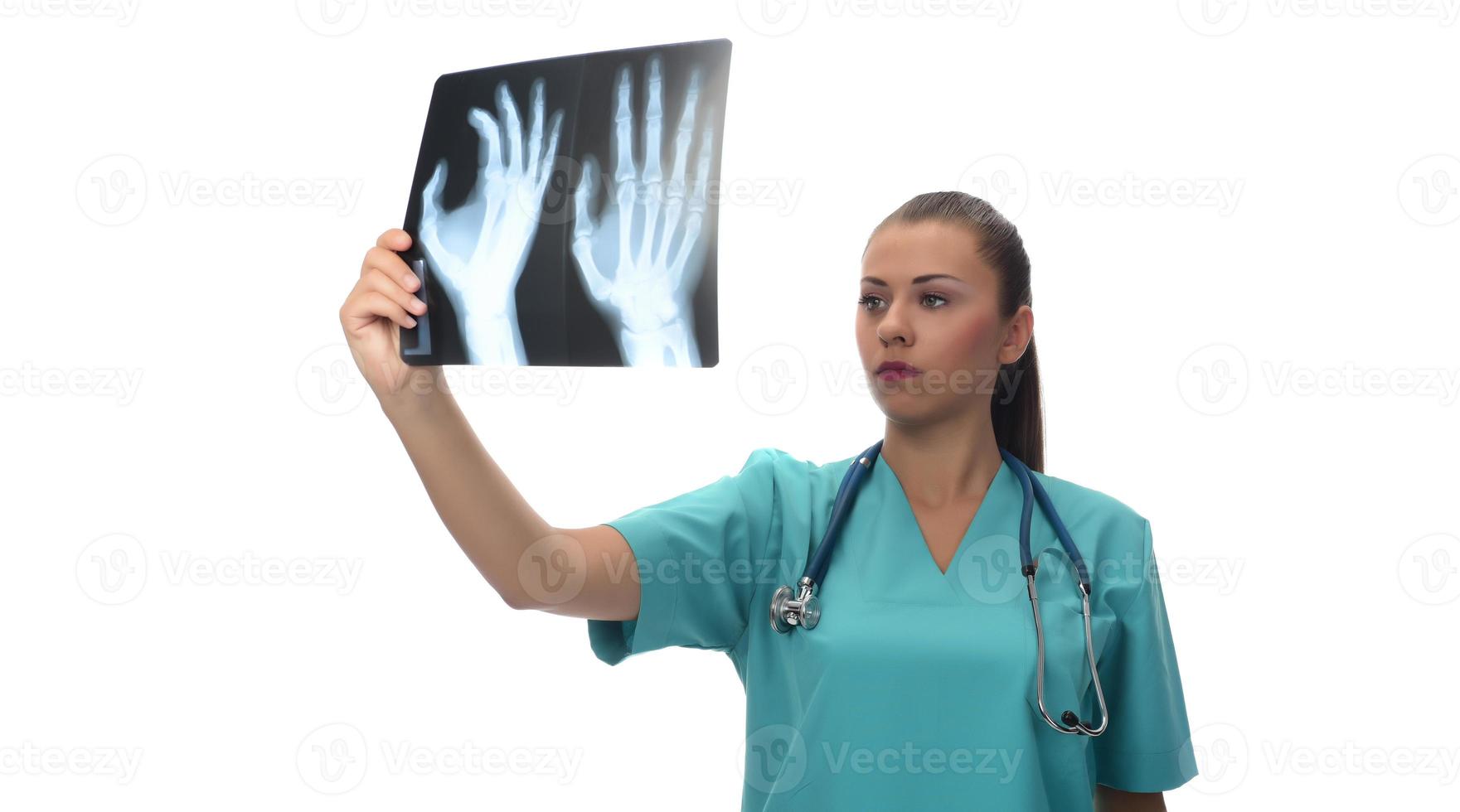 Young female doctor looking at the patient x-ray photo