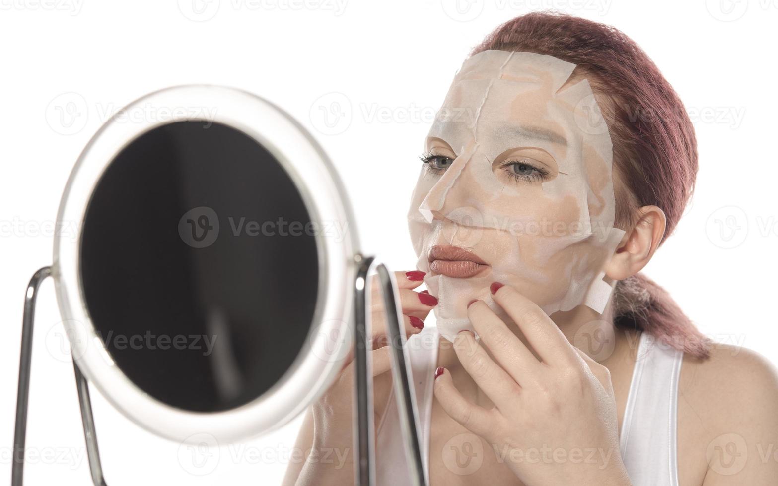 Cosmetic procedure. Woman's face with white cosmetic mask photo