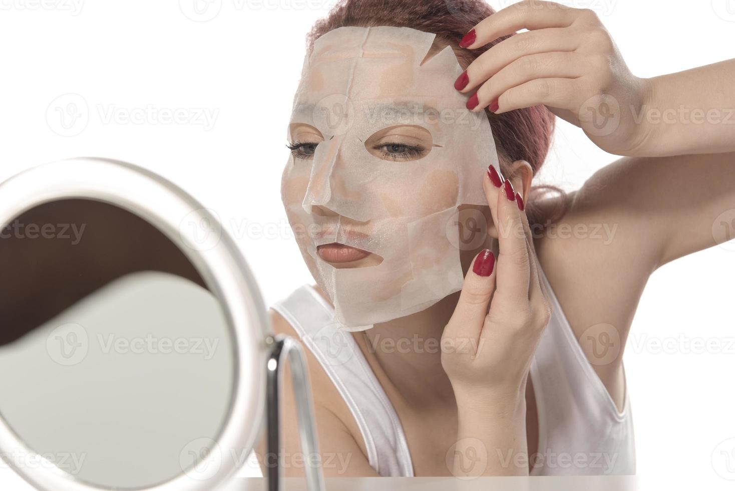 Cosmetic procedure. Woman's face with white cosmetic mask photo