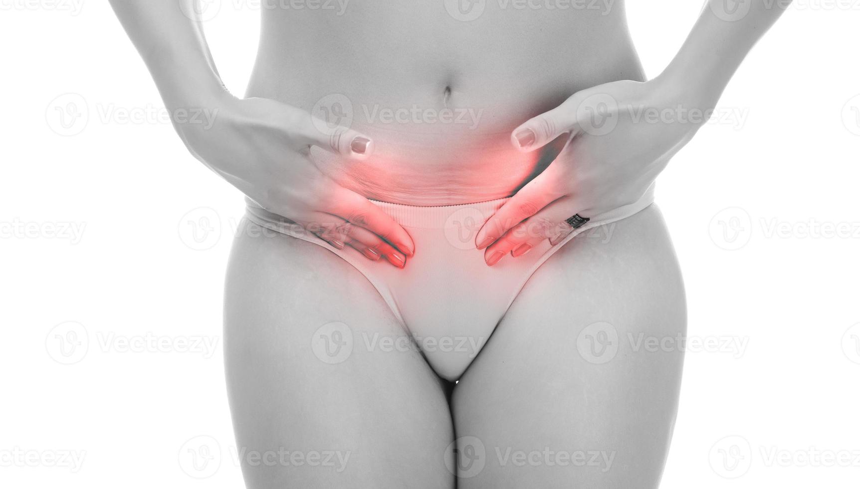 girl covering her crotch with her hands. simulating crotch pain. isolated on white photo