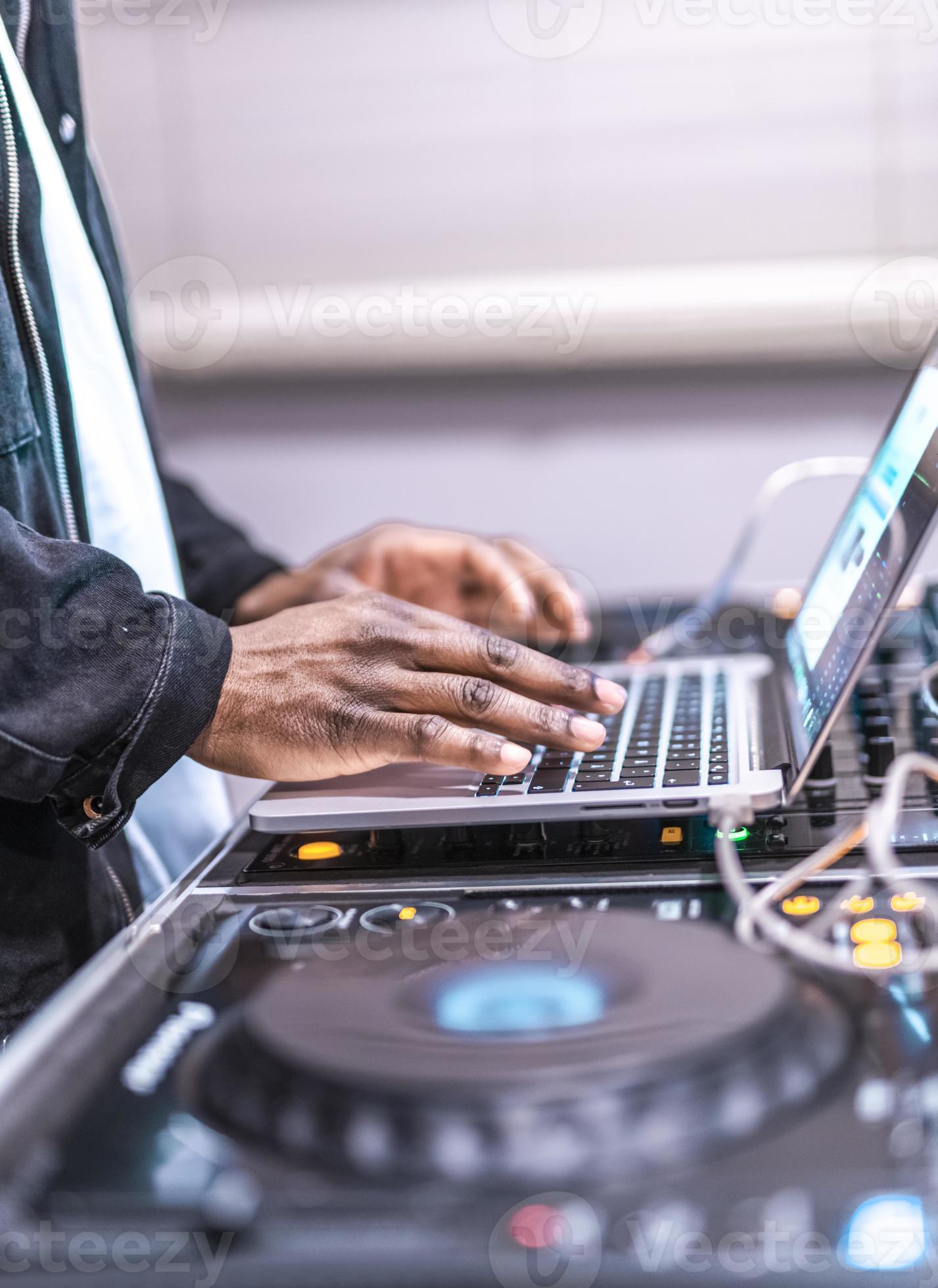 DJ plays live set and mixing music on laptop. Disc Jokey Hands on a laptop at club. 15473607