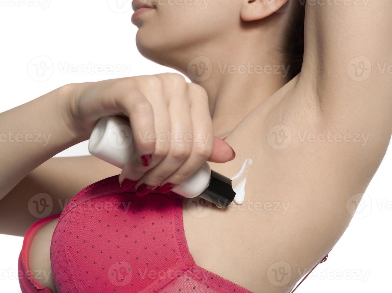 Woman shaves her underarm armpit with razor photo