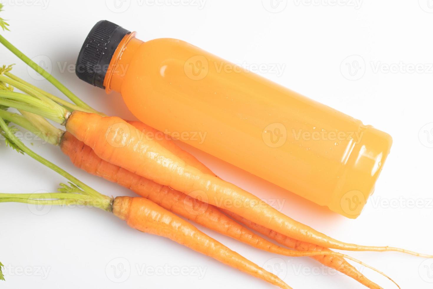 Carrot juice in a clear plastic bottle. Healthy drink. photo