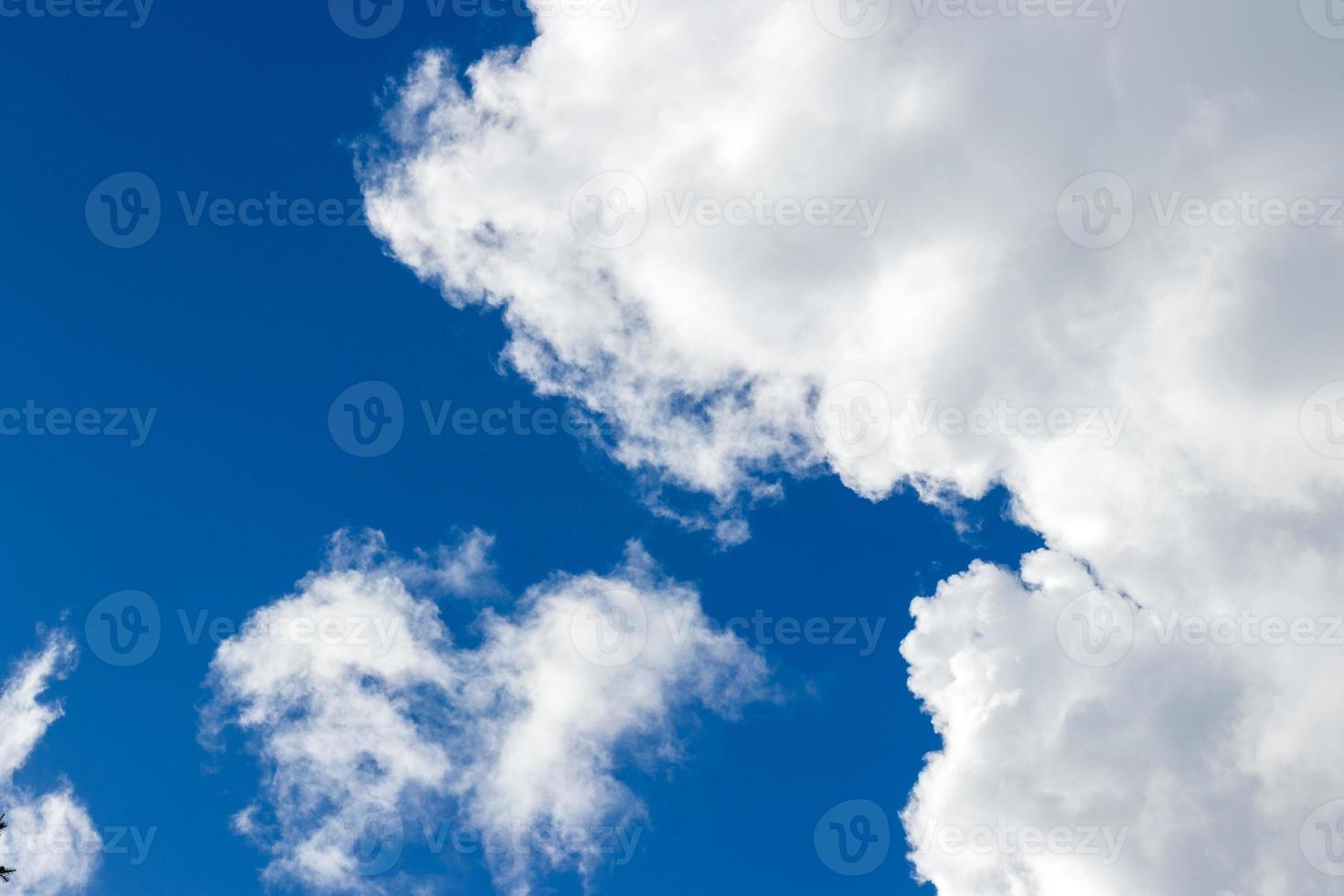 Light fluffy clouds against a blue sky photo
