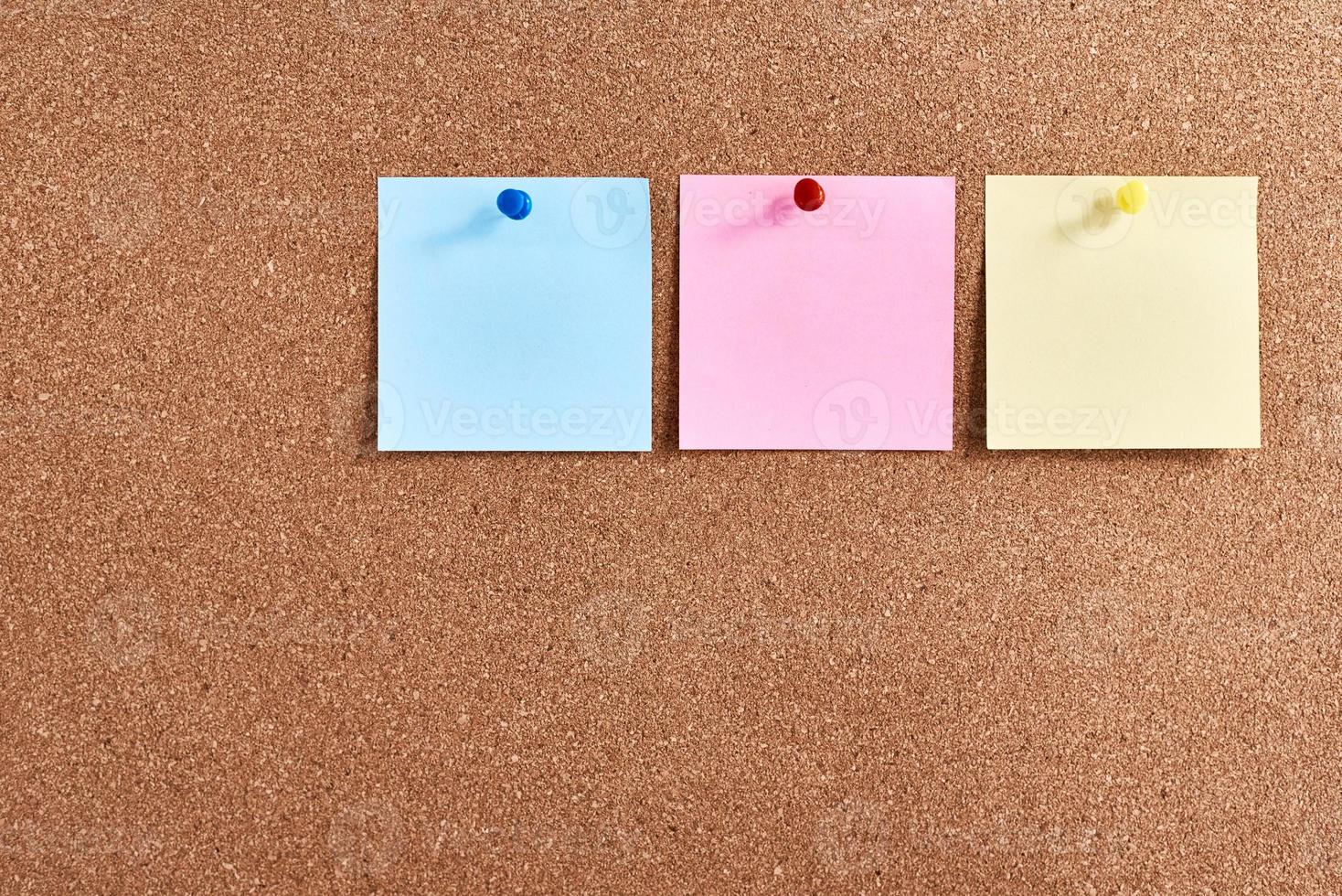 Three sticky notes pinned on a cork board. Planning and brainstorming concept photo