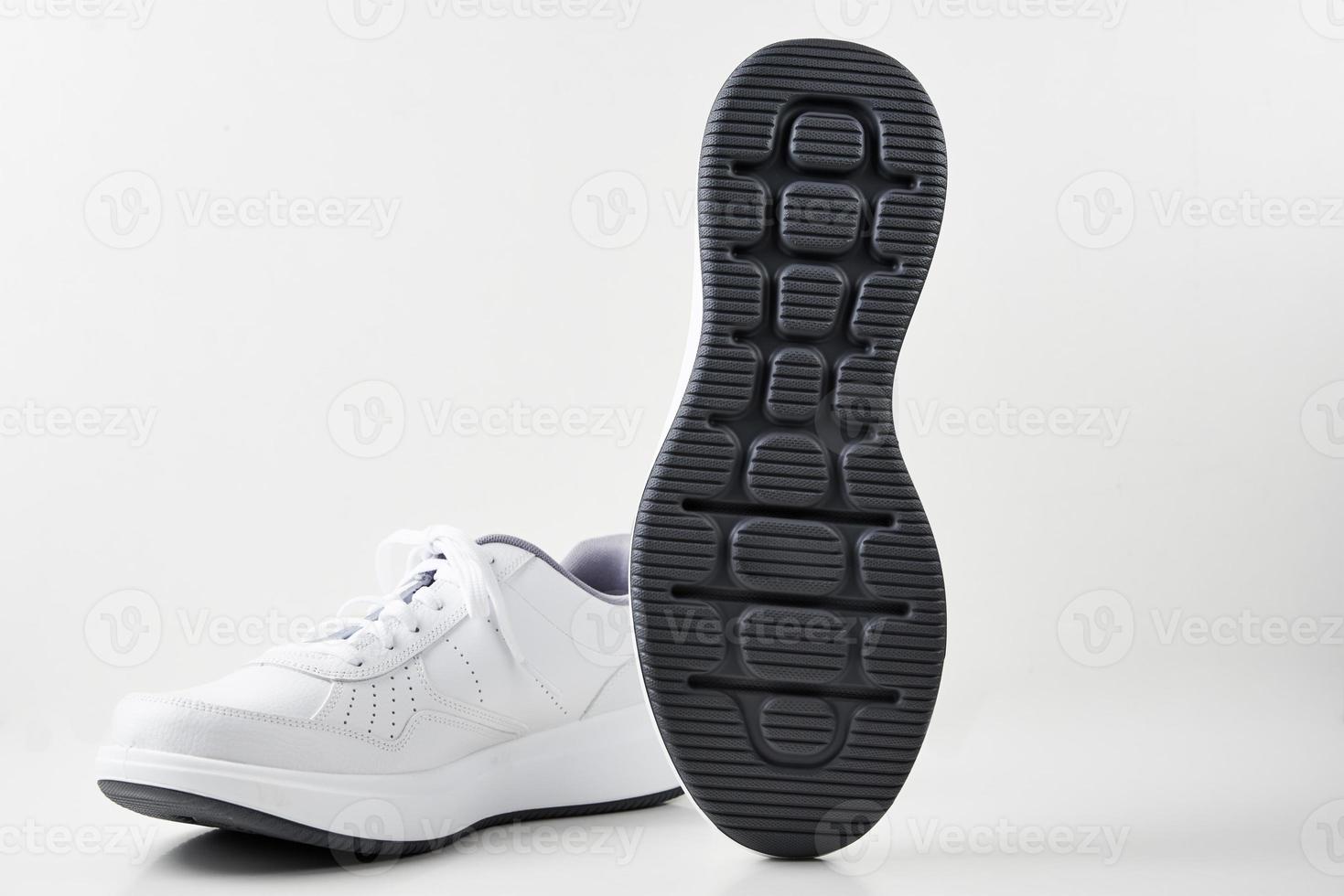 Pair of white male sneakers on white background isolated photo