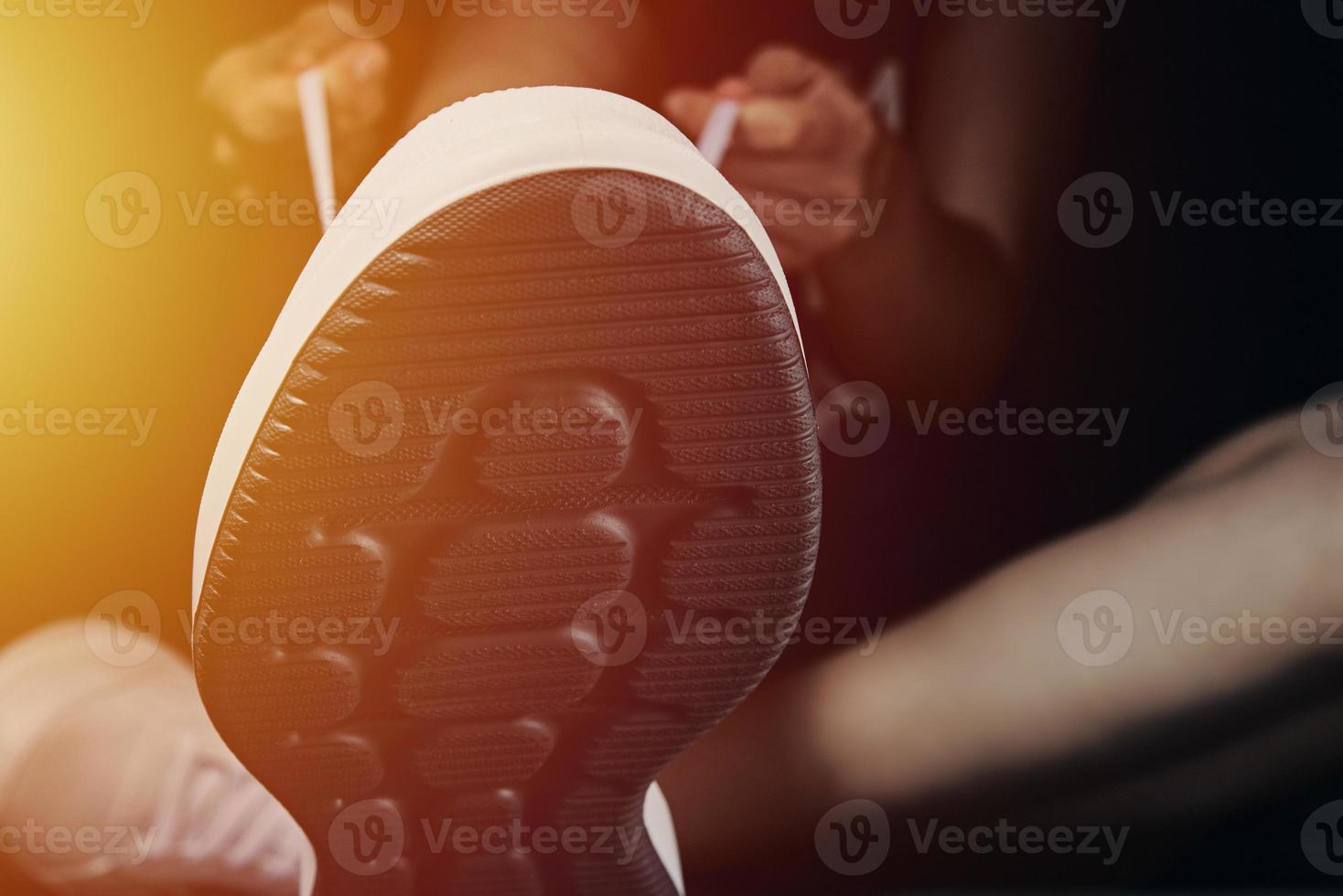 Woman hands tying shoelaces on sneakerss photo