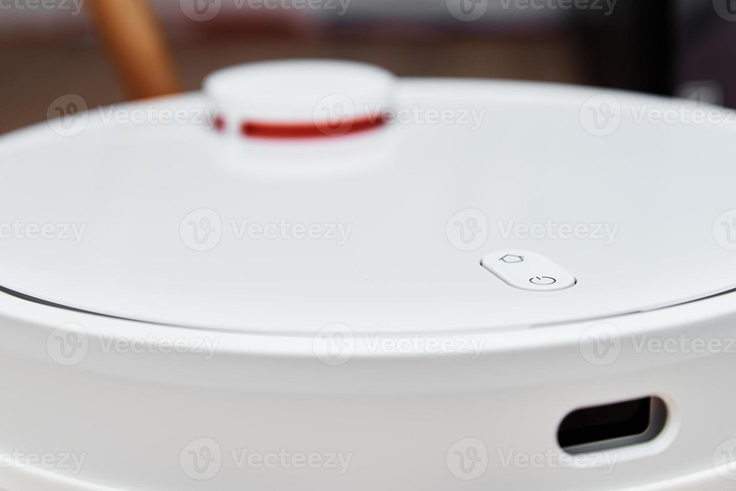 Robot vacuum cleaner working on the floor, top view. Modern smart household photo