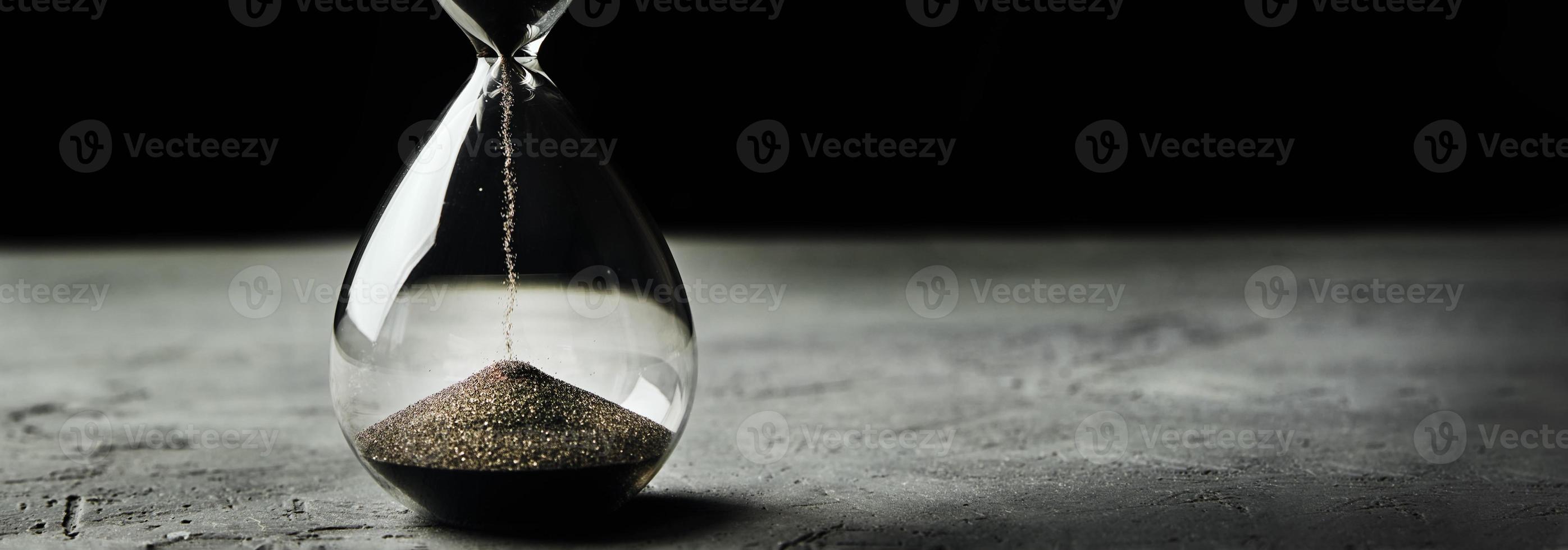 Hourglass on a dark background, long banner photo