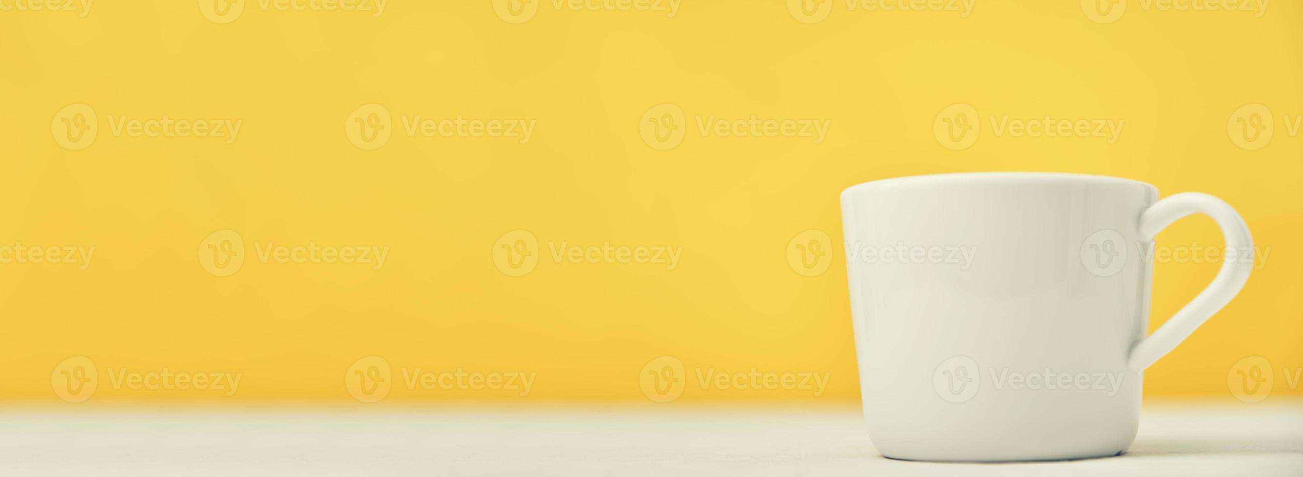 White cup on a yellow background with copy space, long banner photo