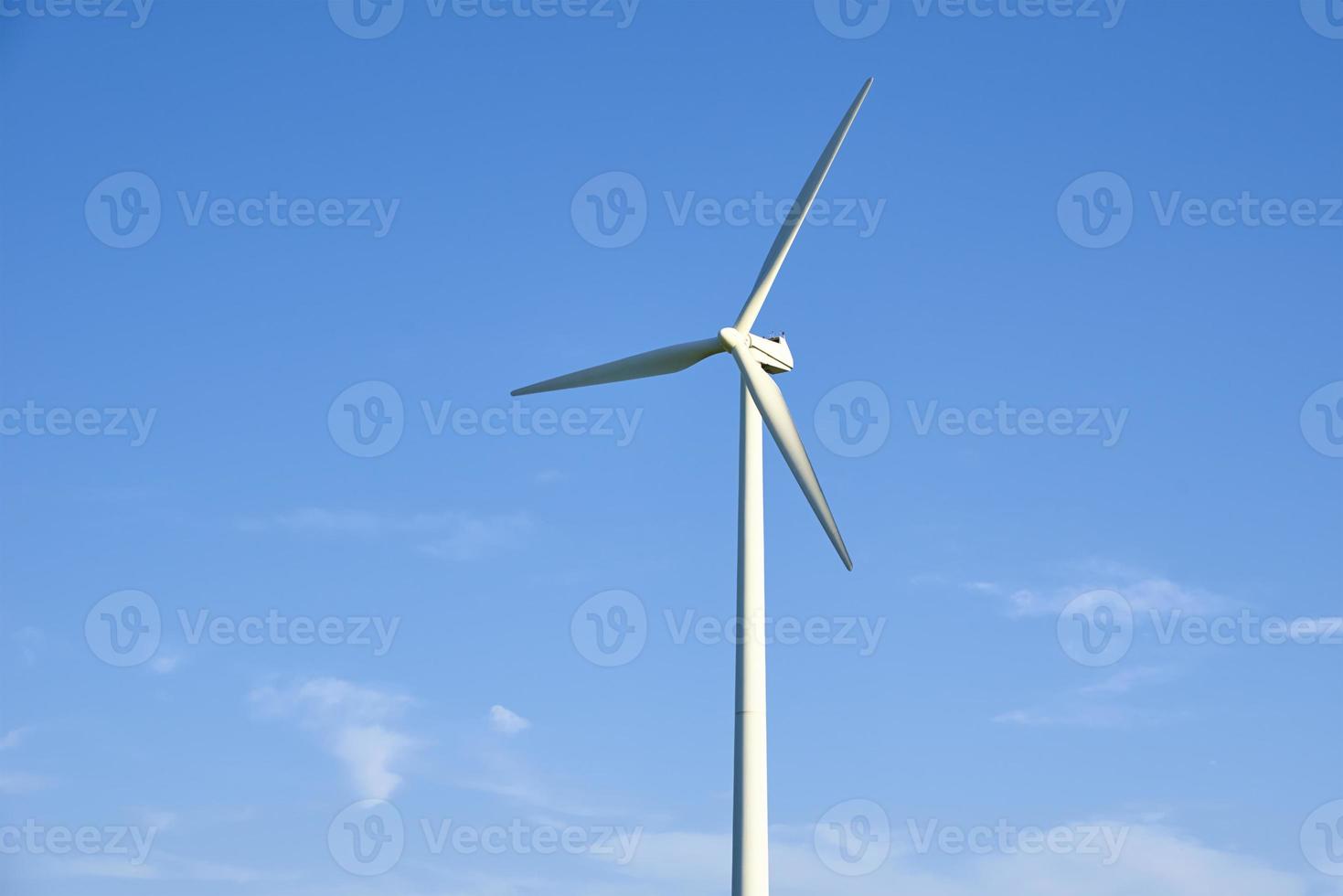 Wind turbine against blue sky. Wind power energy concept photo
