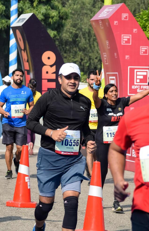 New Delhi, India - October 16 2022 - Vedanta Delhi Half Marathon race after covid in which marathon participants about to cross the finish line, Delhi Half Marathon 2022 photo
