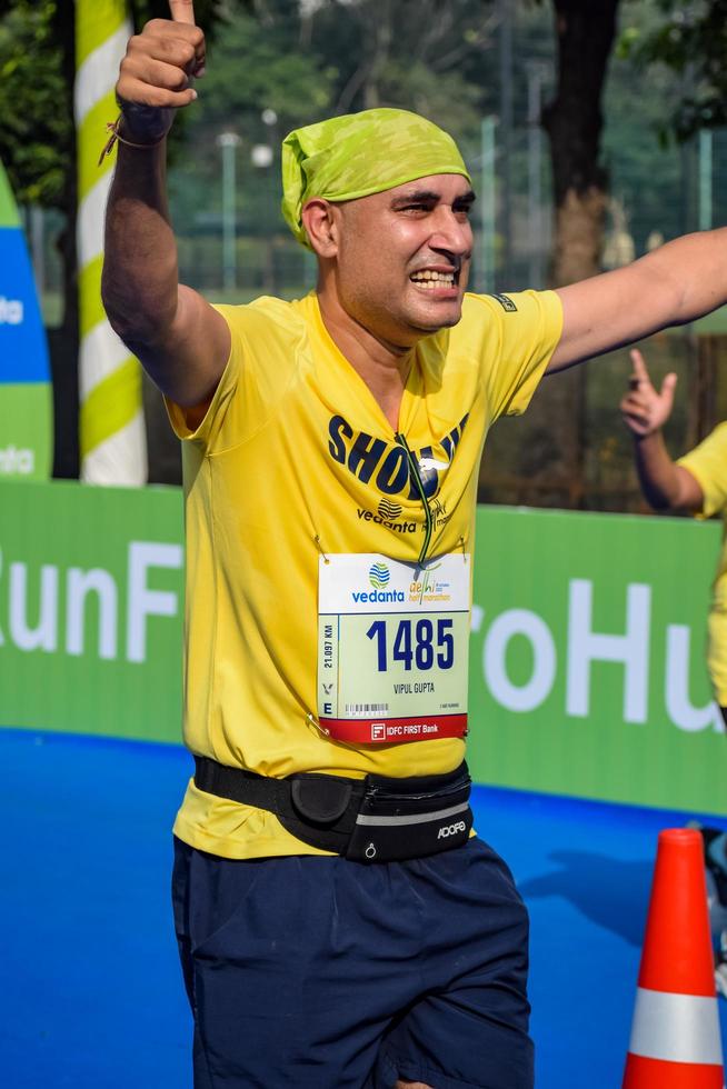 New Delhi, India - October 16 2022 - Vedanta Delhi Half Marathon race after covid in which marathon participants about to cross the finish line, Delhi Half Marathon 2022 photo