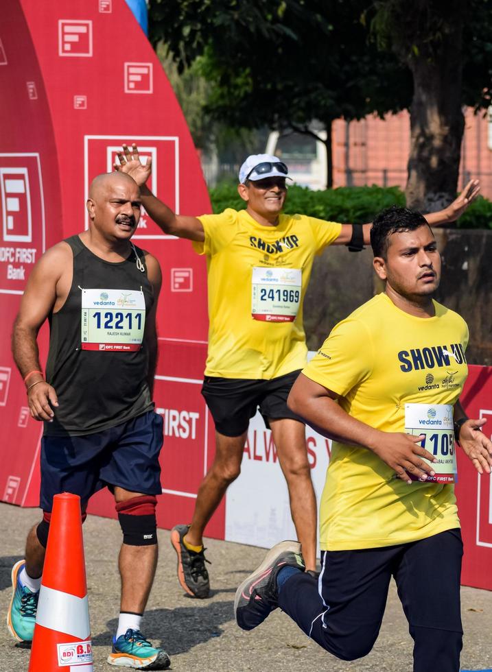 New Delhi, India - October 16 2022 - Vedanta Delhi Half Marathon race after covid in which marathon participants about to cross the finish line, Delhi Half Marathon 2022 photo