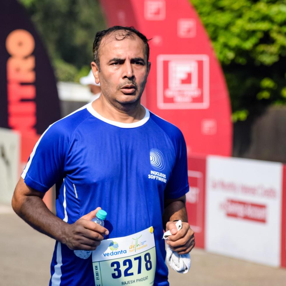 New Delhi, India - October 16 2022 - Vedanta Delhi Half Marathon race after covid in which marathon participants about to cross the finish line, Delhi Half Marathon 2022 photo