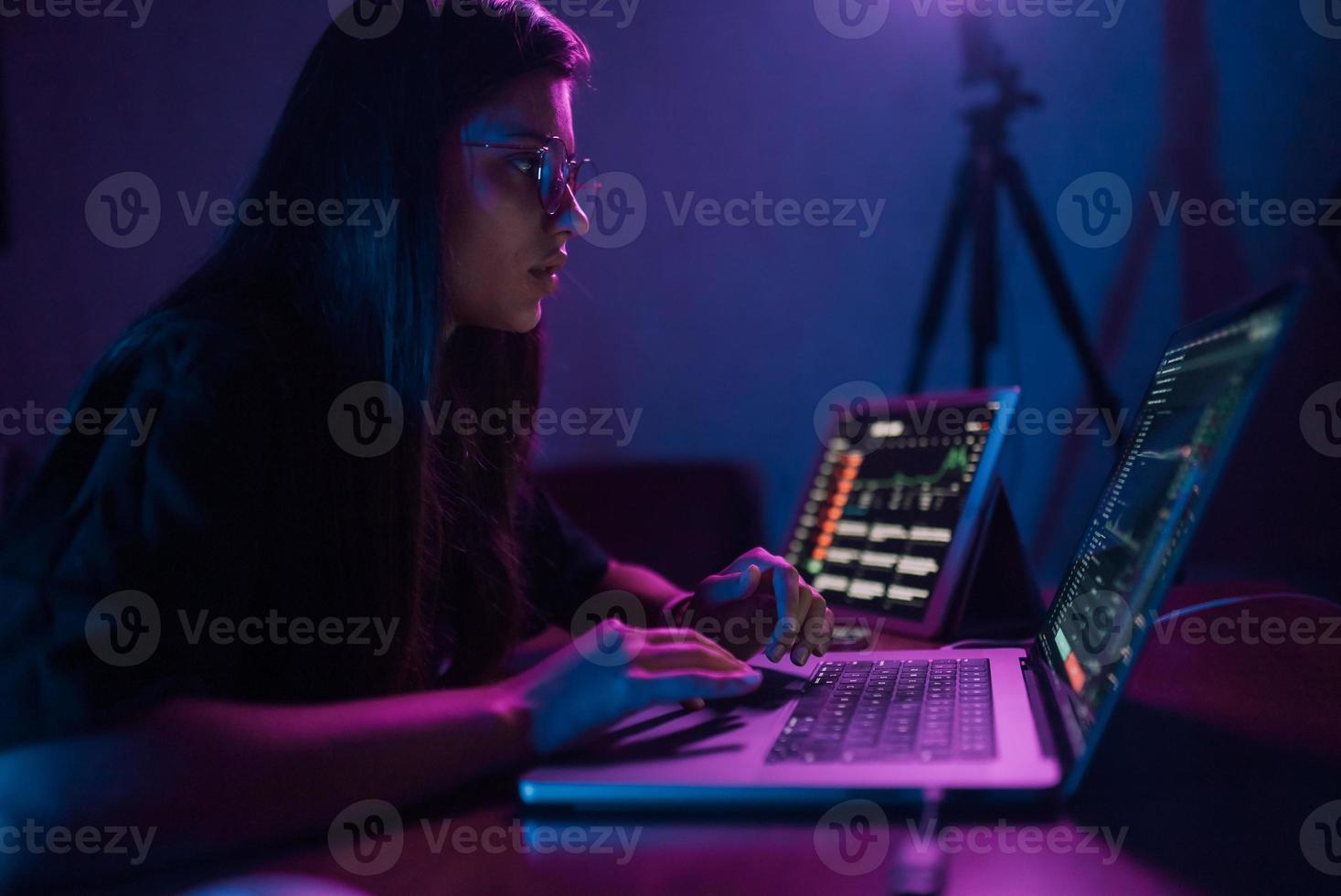 Attractive young woman working in home at night. photo