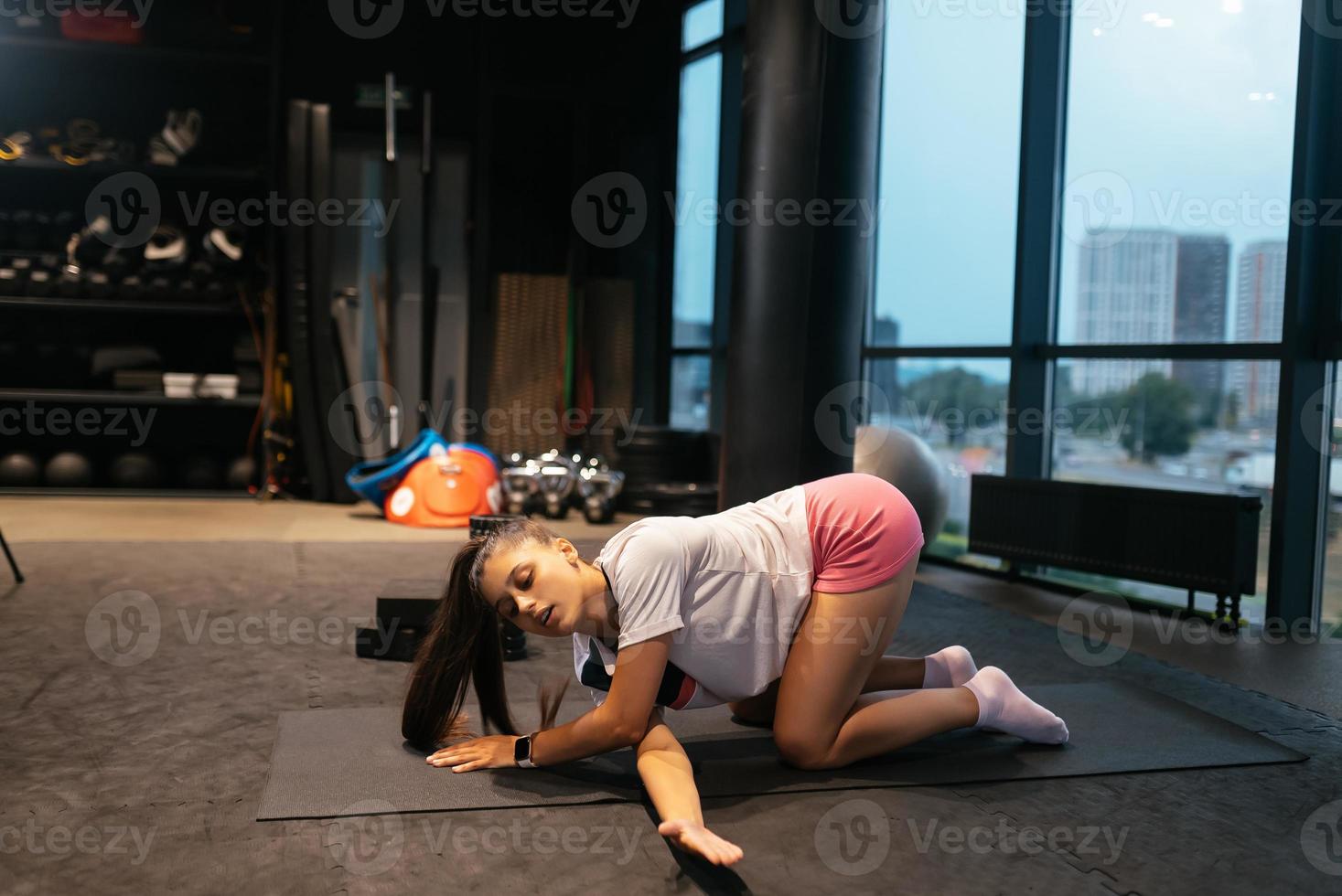 Young woman doing exercises in the gym photo