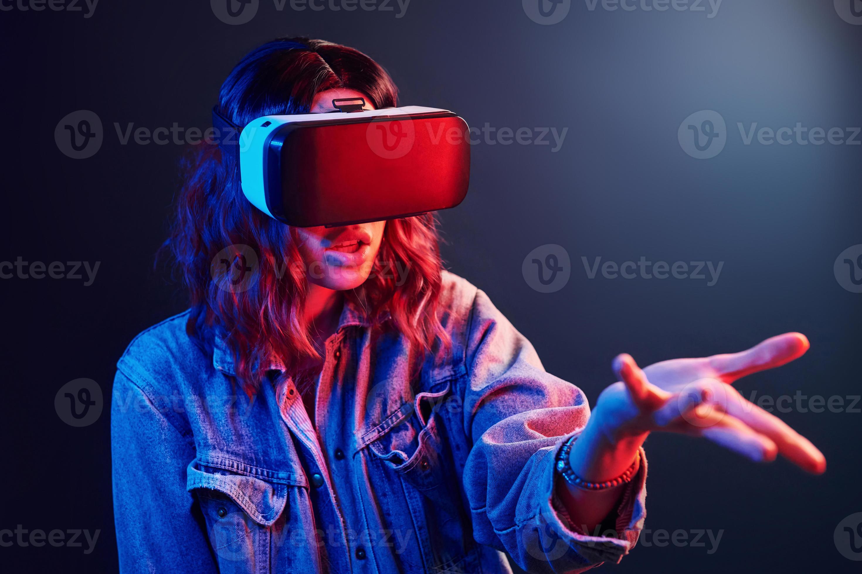 Facial expression of young girl with virtual reality glasses on head in