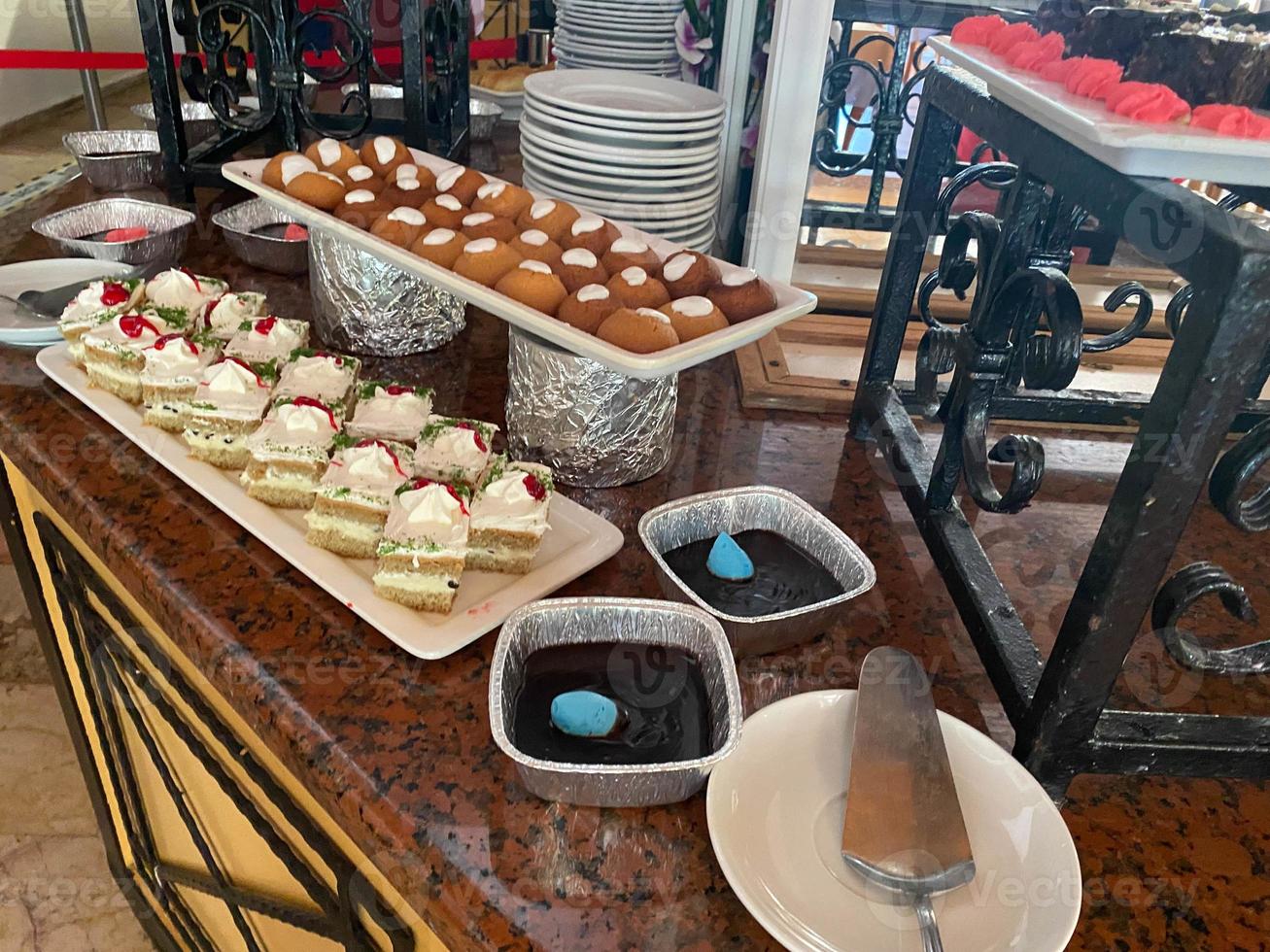 Pastries with fruit and pistachios on the buffet table photo