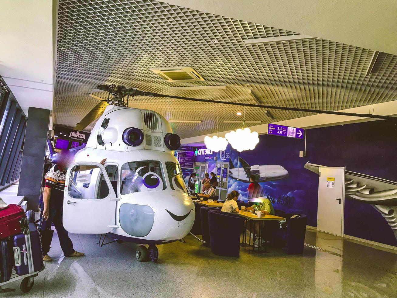 at the airport there is a toy plane for children. mock-up of an airplane with a propeller and a smile for little passengers. entertaining children in a public place photo