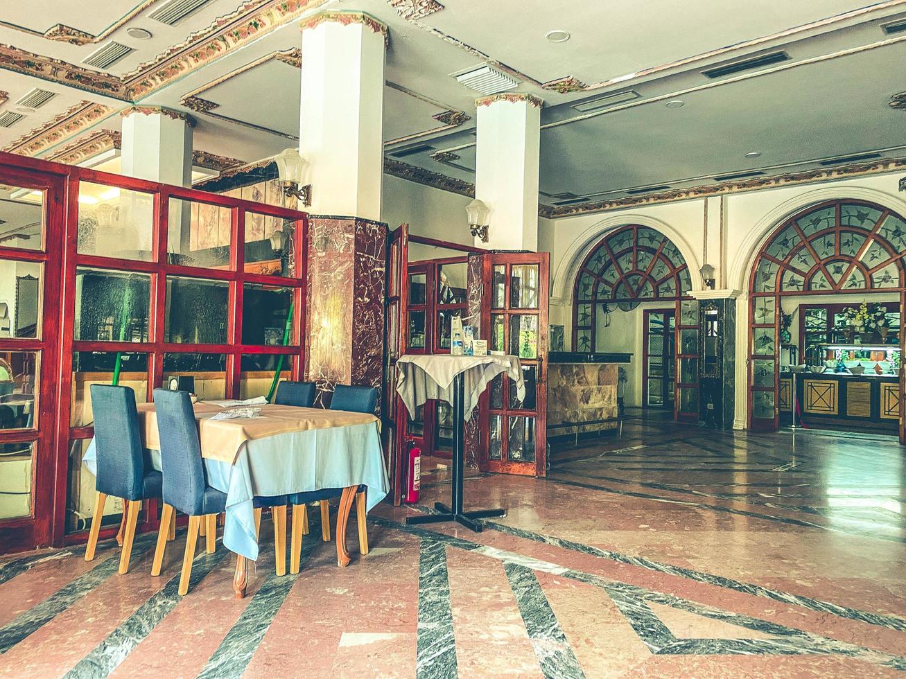 spacious lounge with tables and chairs. dining room in the hotel for meals. ceramic tiles on the floor, large-format material photo