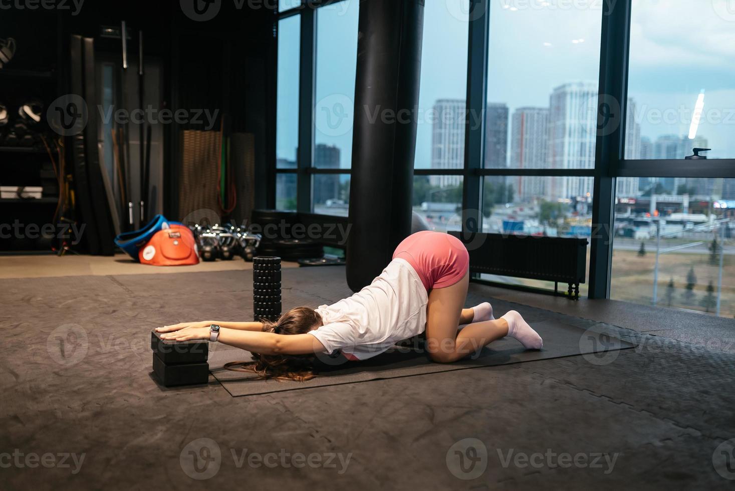 Young woman doing exercises in the gym photo