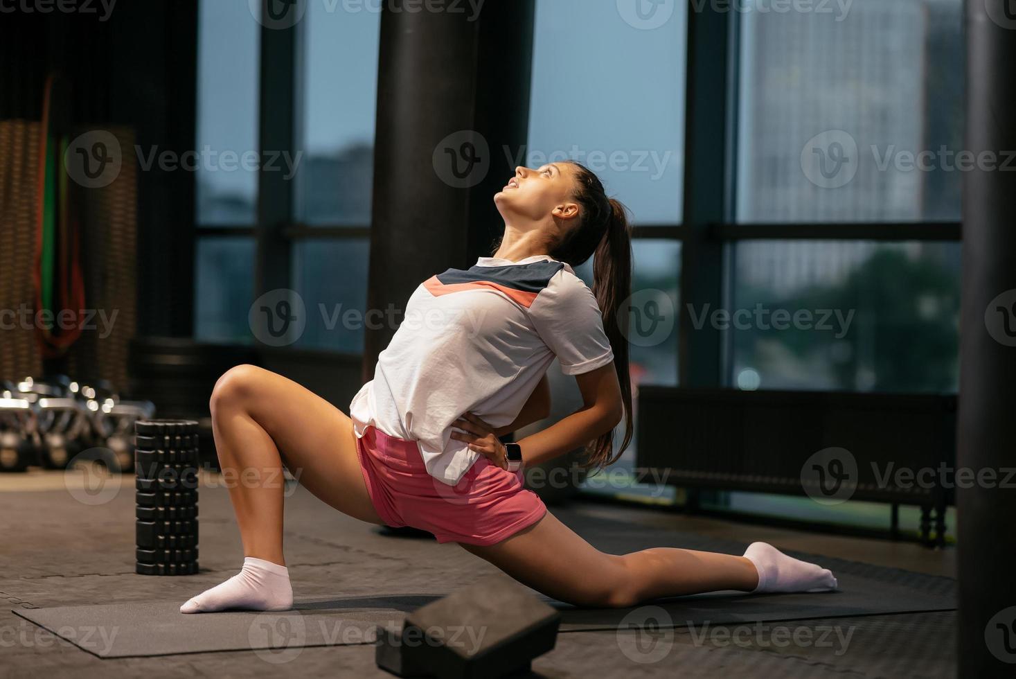 Young woman working out, doing yoga or pilates exercise photo