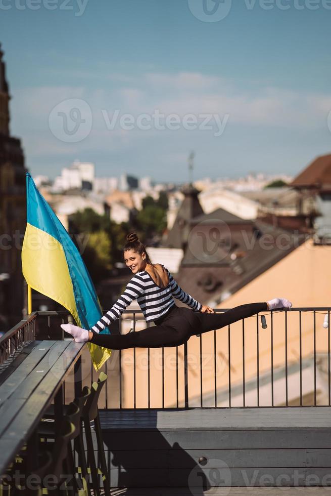 A young woman is doing twine on the roof of the house photo