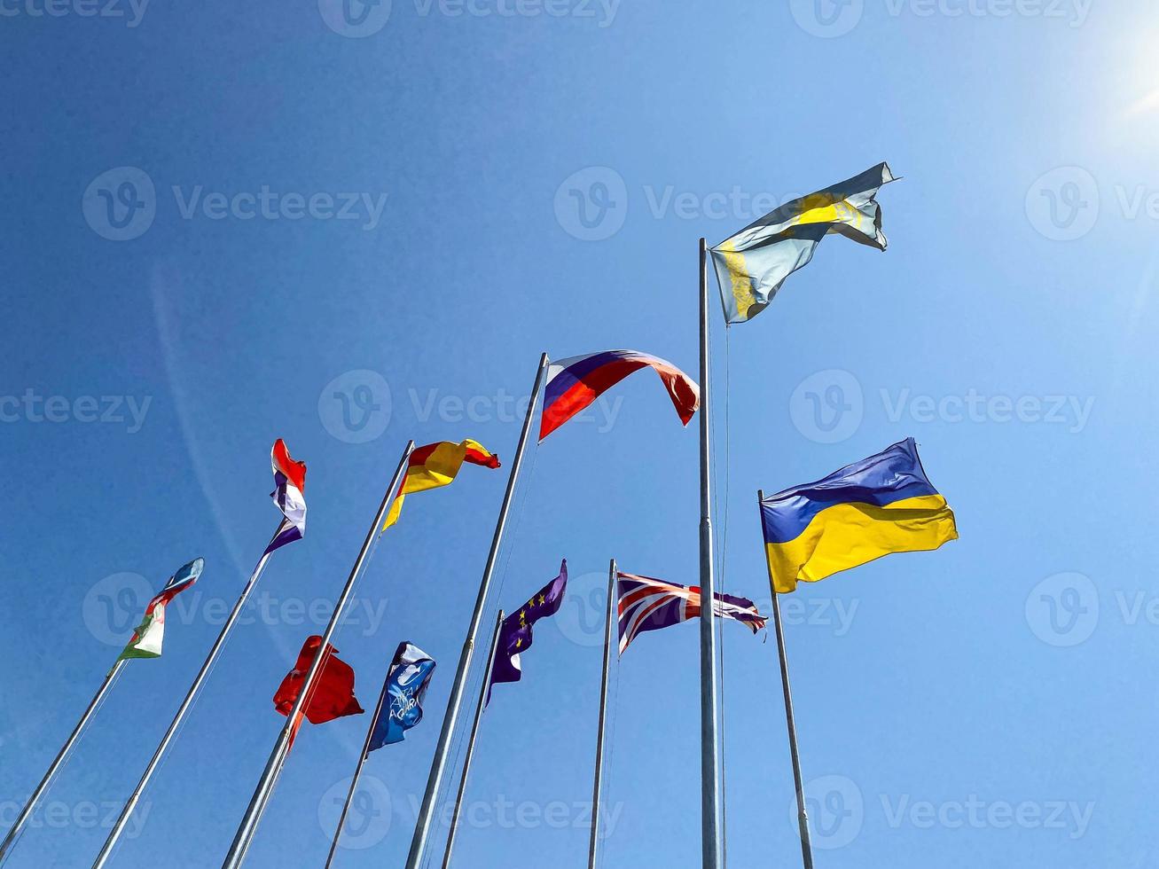 central square in the city. on it are flagpoles with flags of different countries. international cooperation, friendship of peoples, ukraine and russia photo