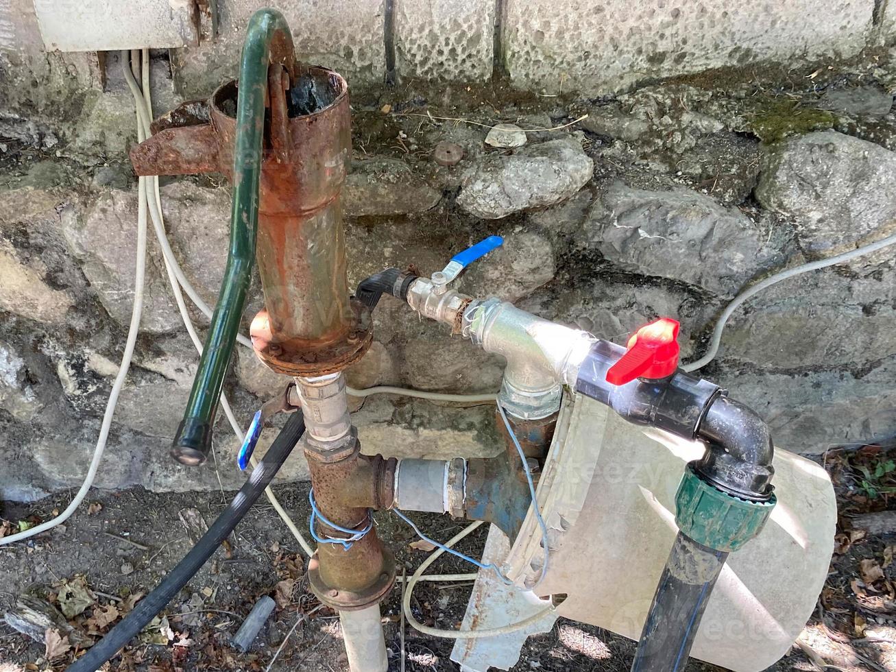 Homemade pump station in a pond for watering the garden photo
