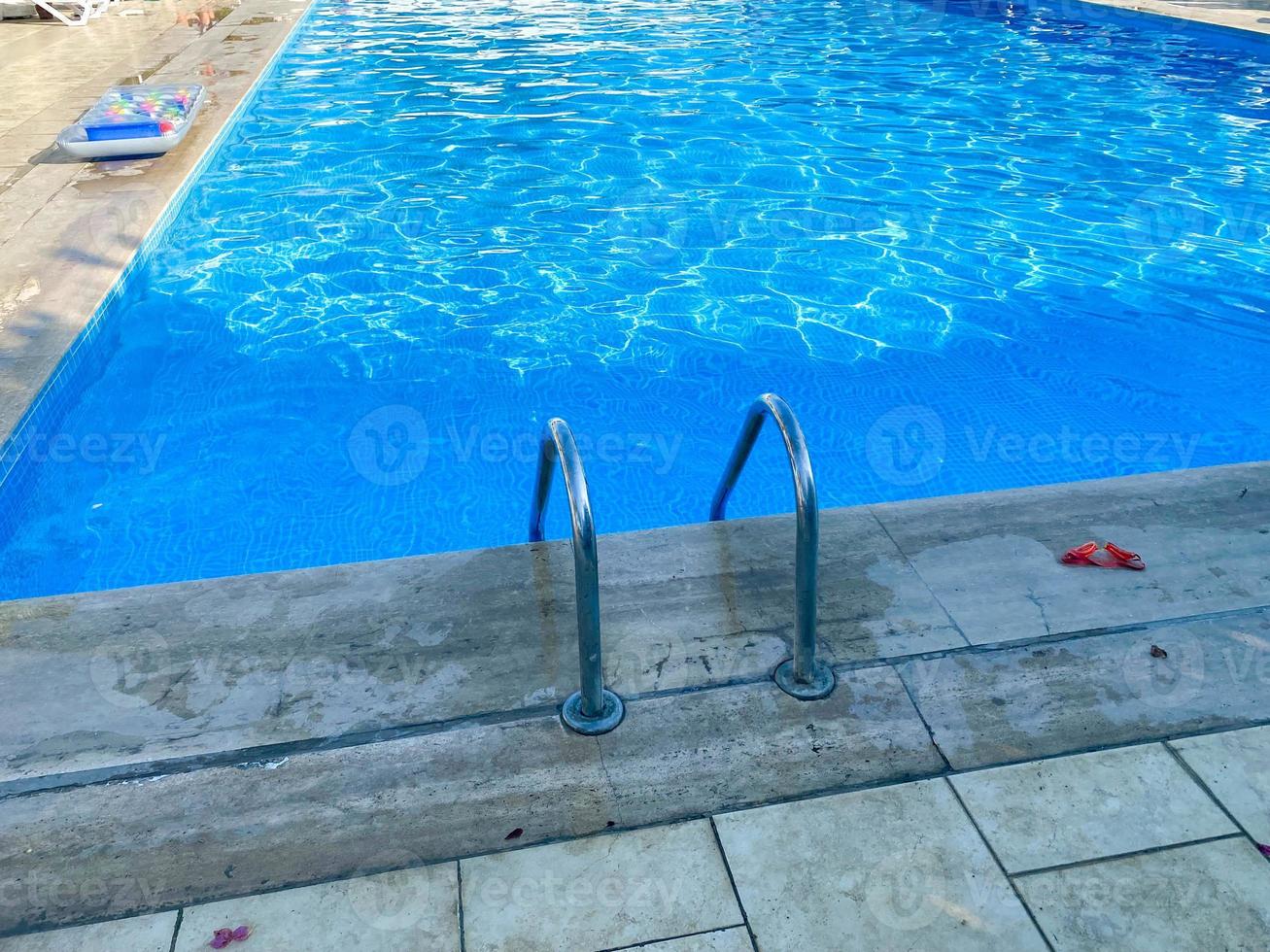 Swimming pool and chila with clear clear blue water in a hotel on vacation in a paradise warm eastern tropical country resort photo