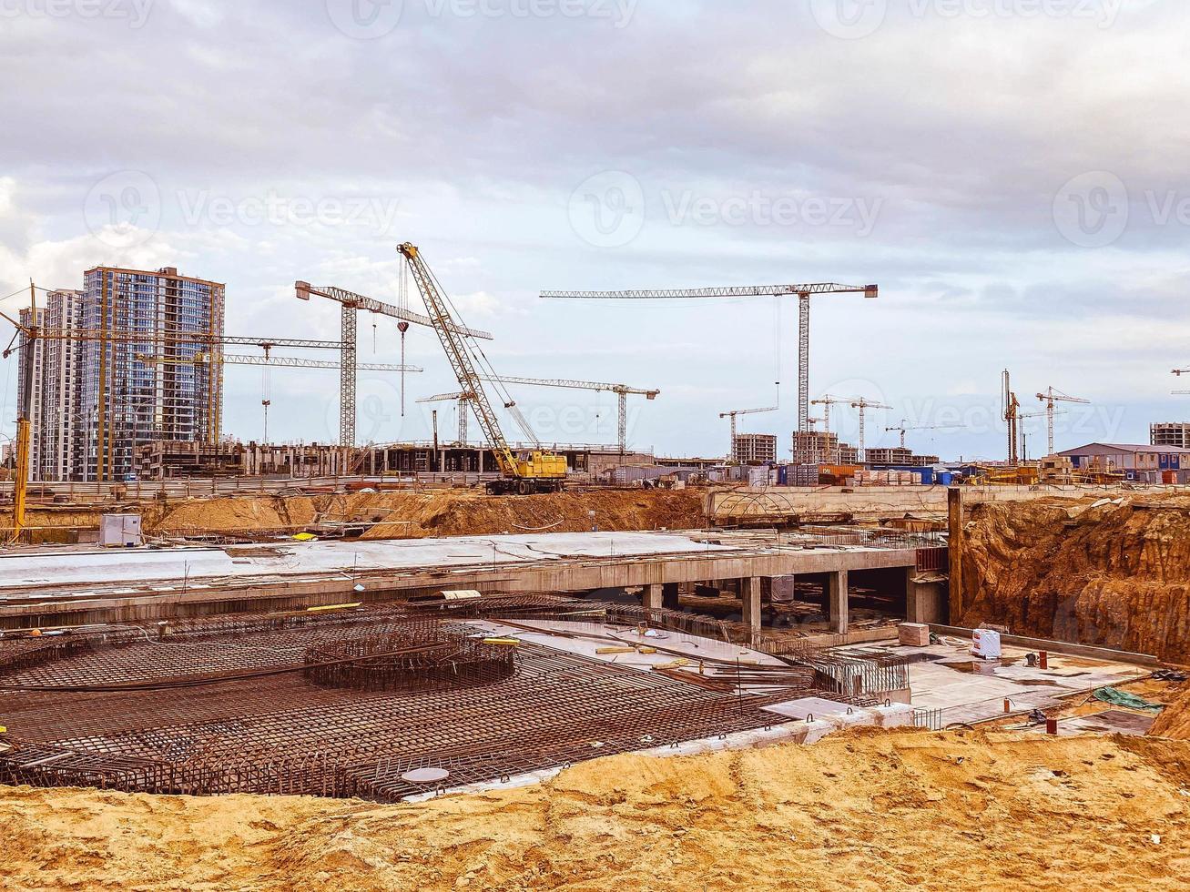 construction of a new residential area in the city center. for the construction of multi-storey buildings there are high-rise cranes. carrying large loads photo