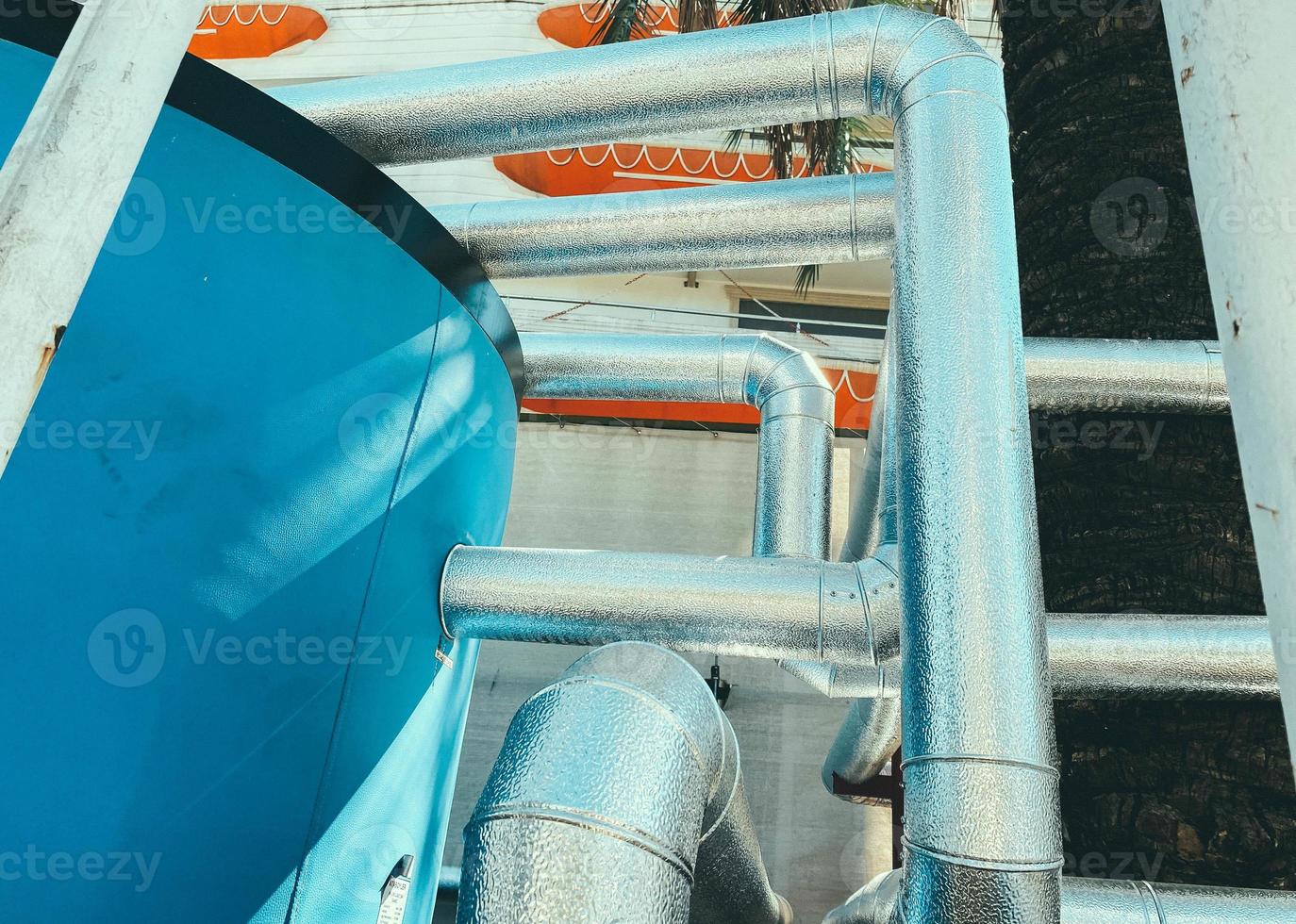 metal equipment. holder for huge barrels of washing water made of durable, reliable gray metal structures. metal frame. barrel of blue photo