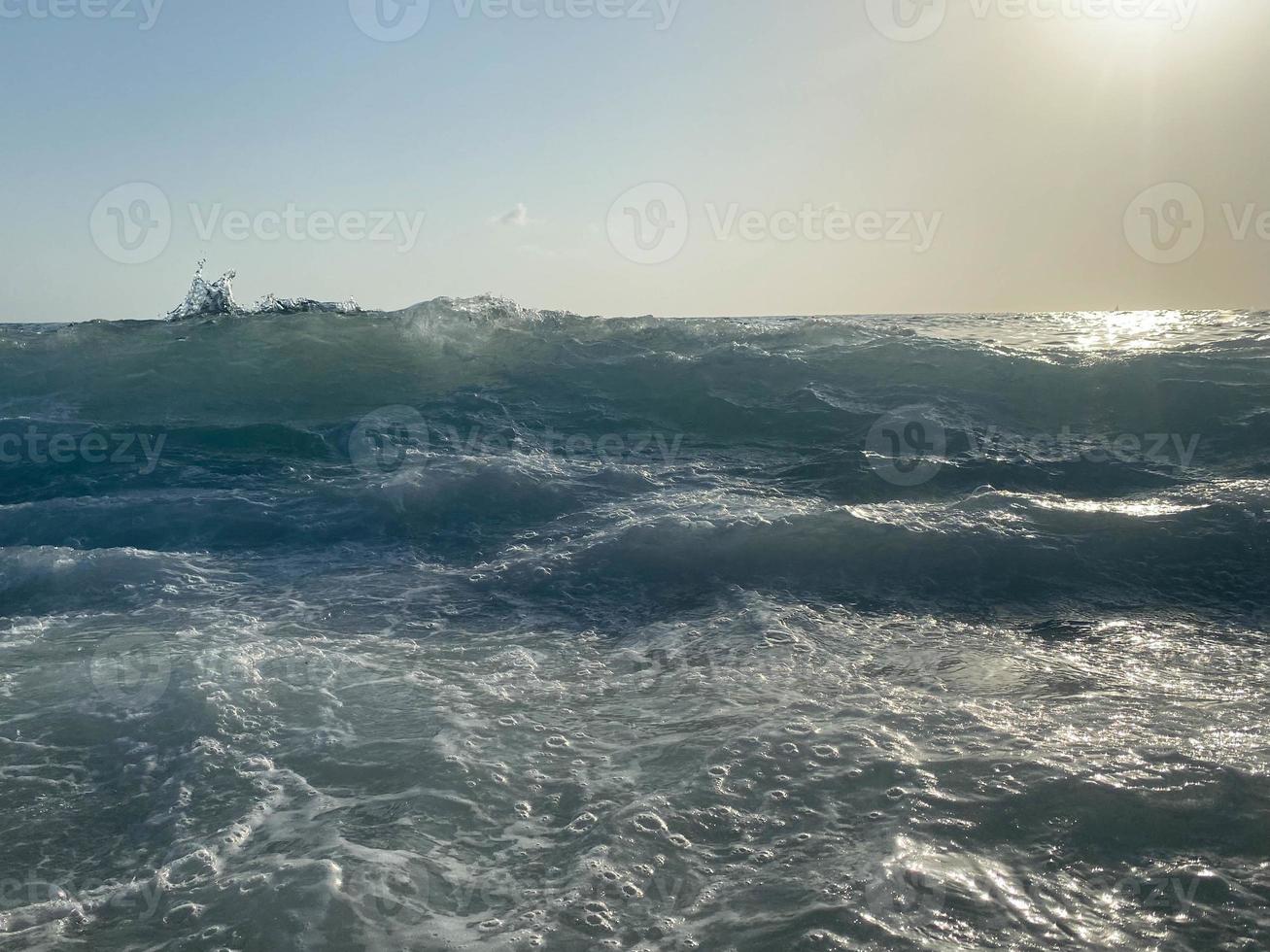 Waves, splashes of water on the beach at the sea on vacation in a tourist warm eastern tropical country southern paradise resort on vacation. The background photo